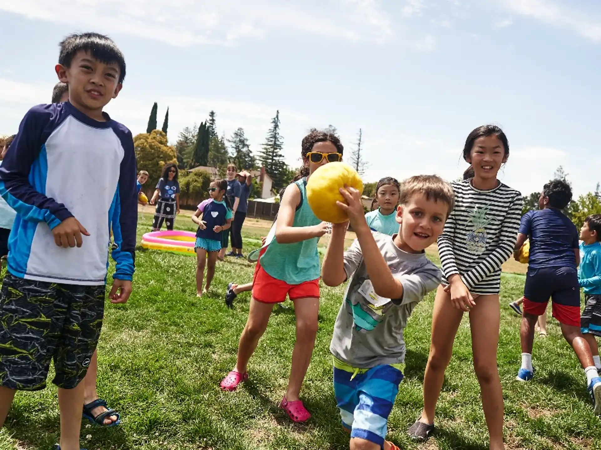 a group of kids playing with a ball