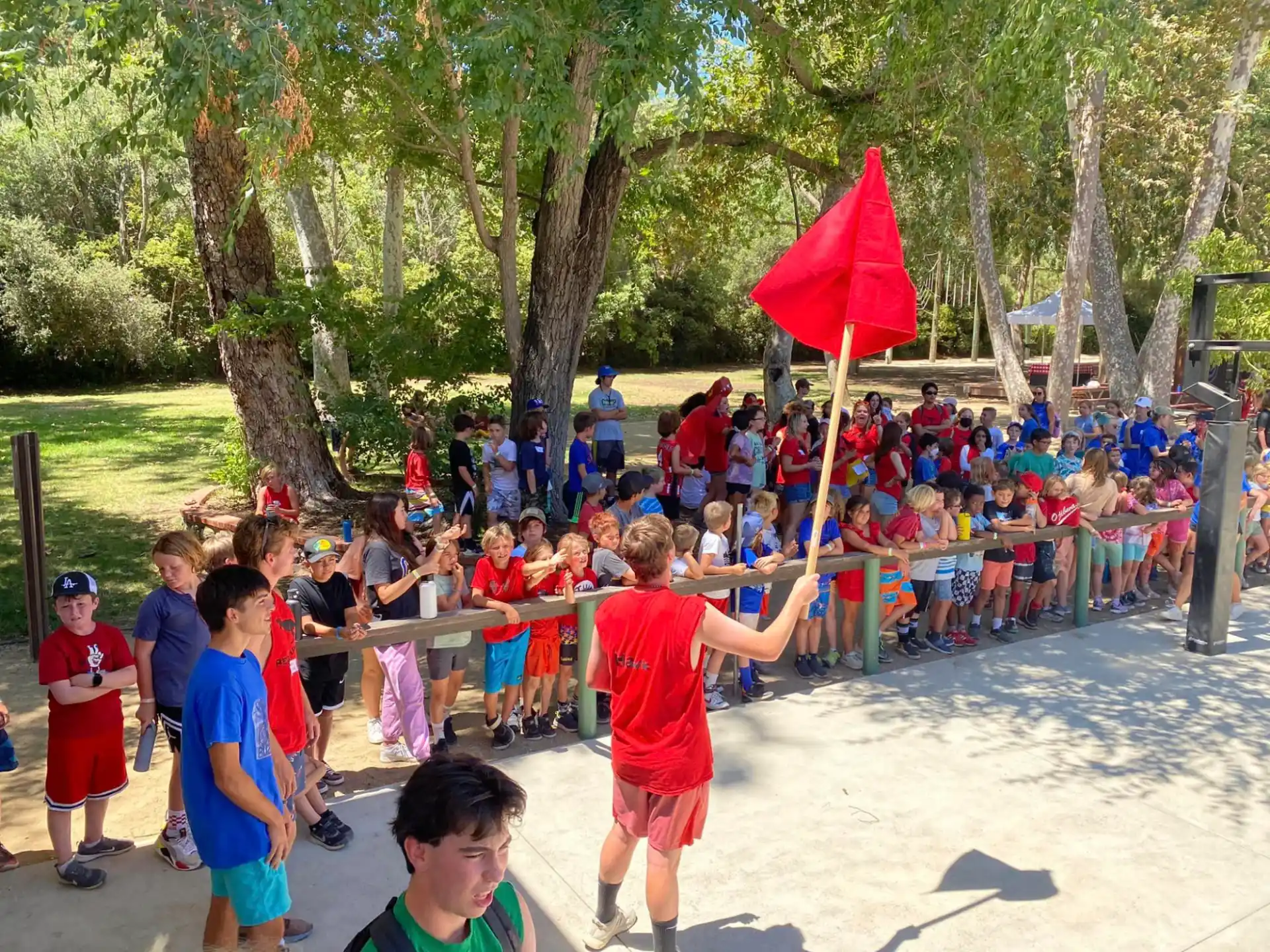 a group of people playing with a red and white object