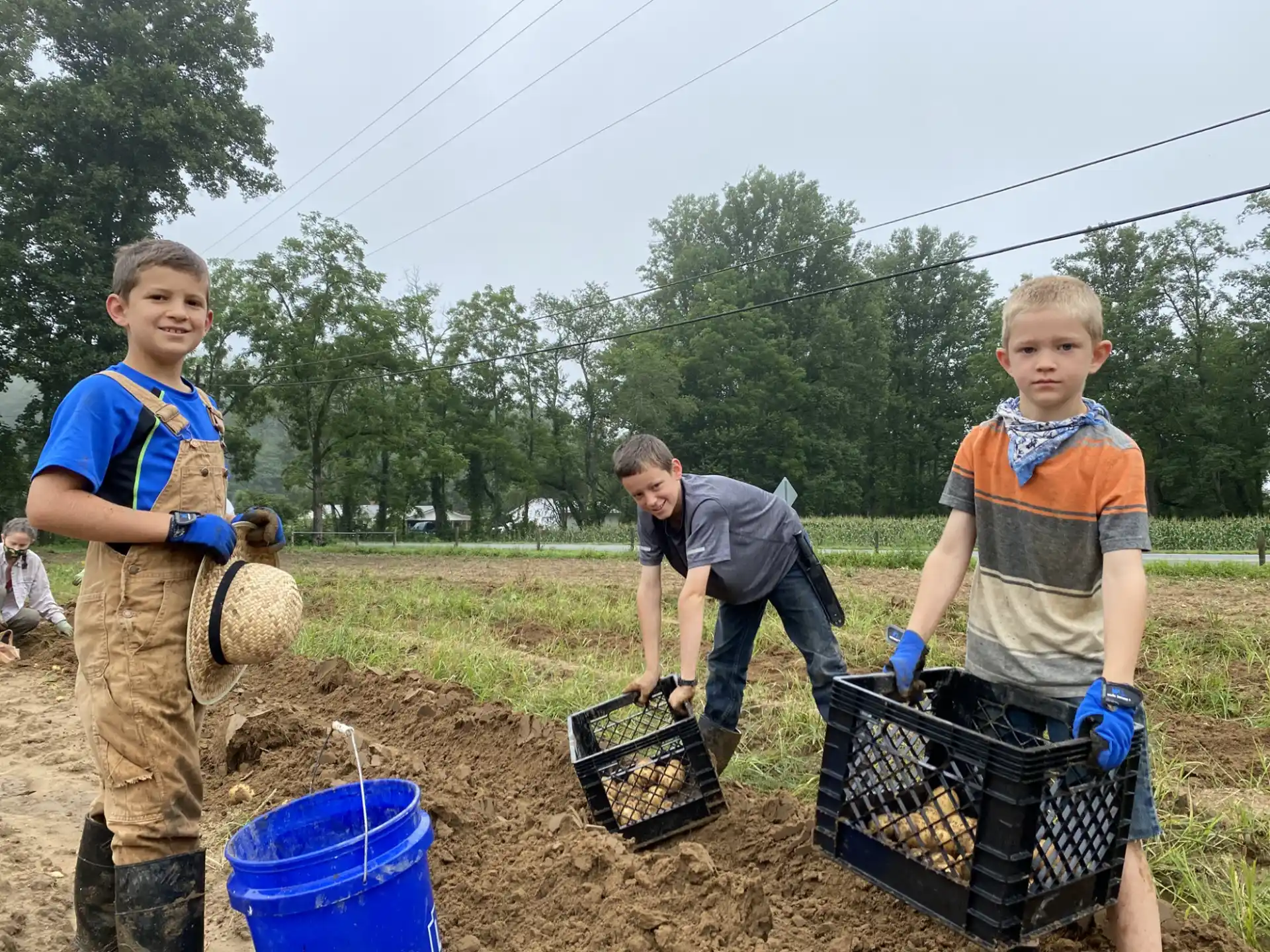 a group of boys holding buckets