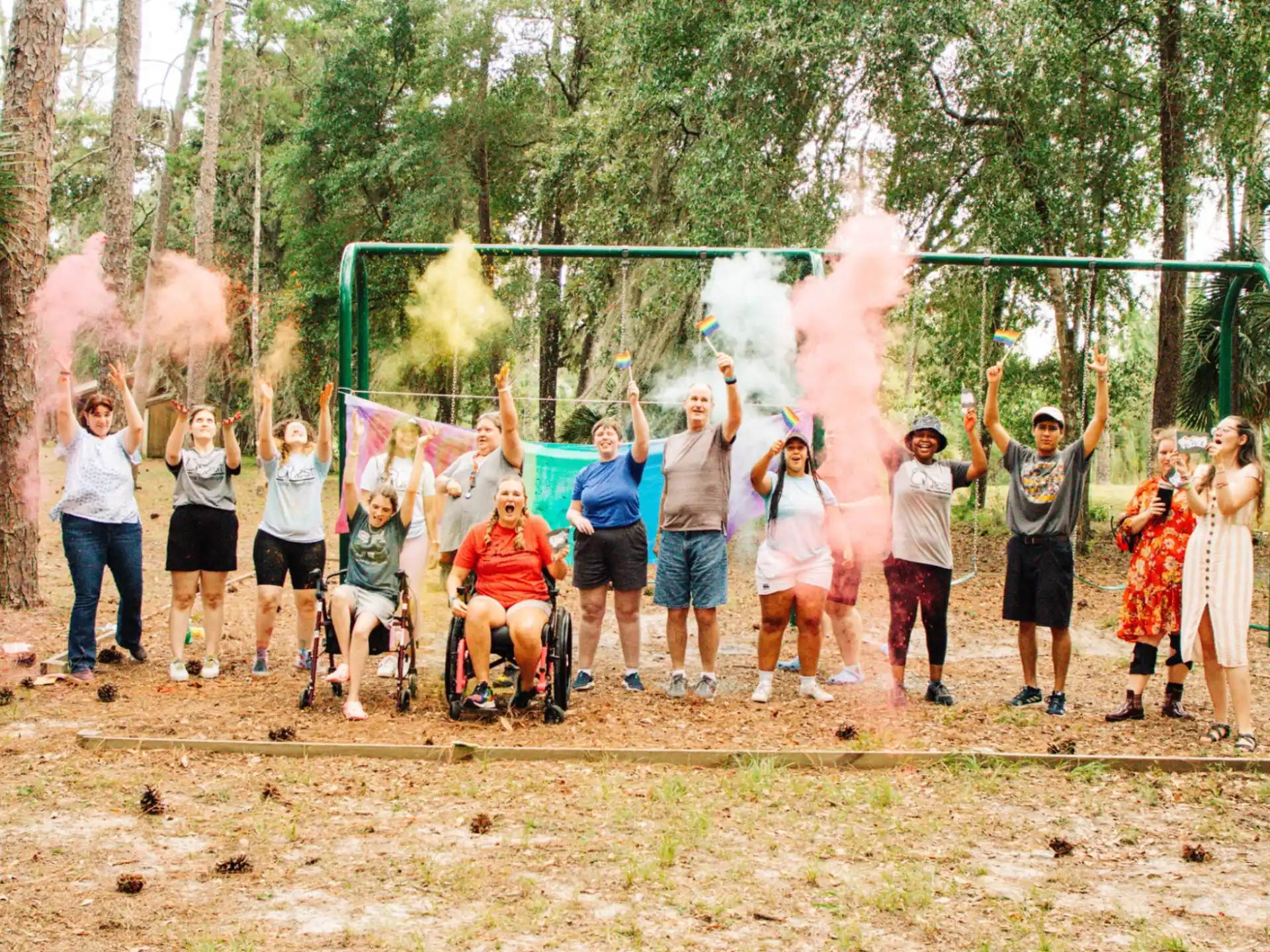 a group of people standing in a circle with a fire in the air