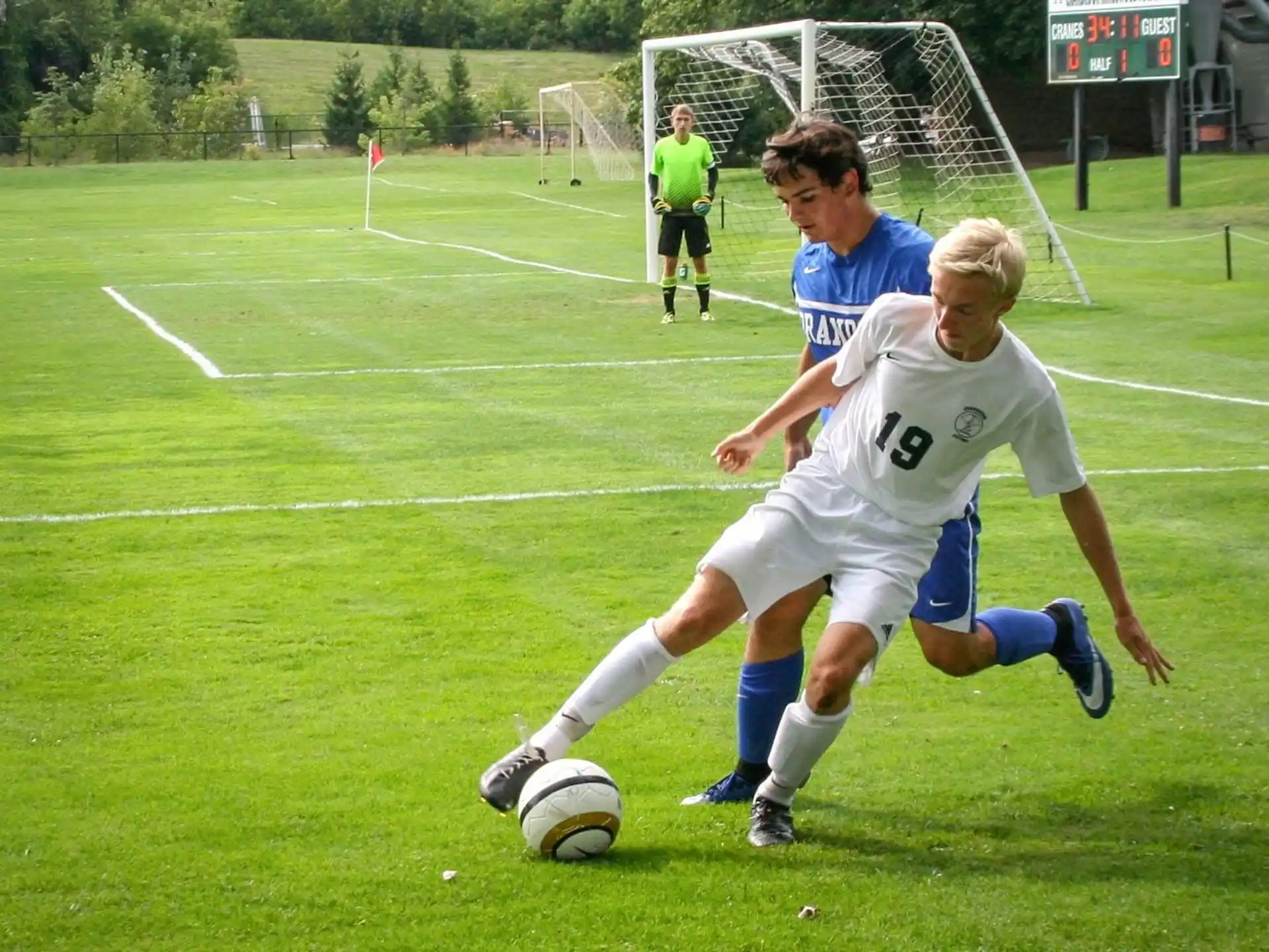 a couple of football players compete over a football ball