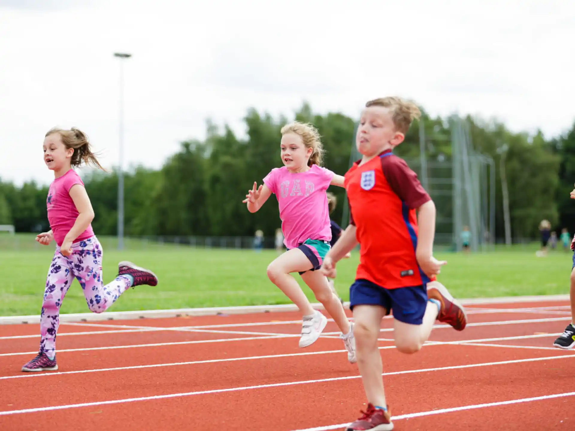 a group of children running on a track