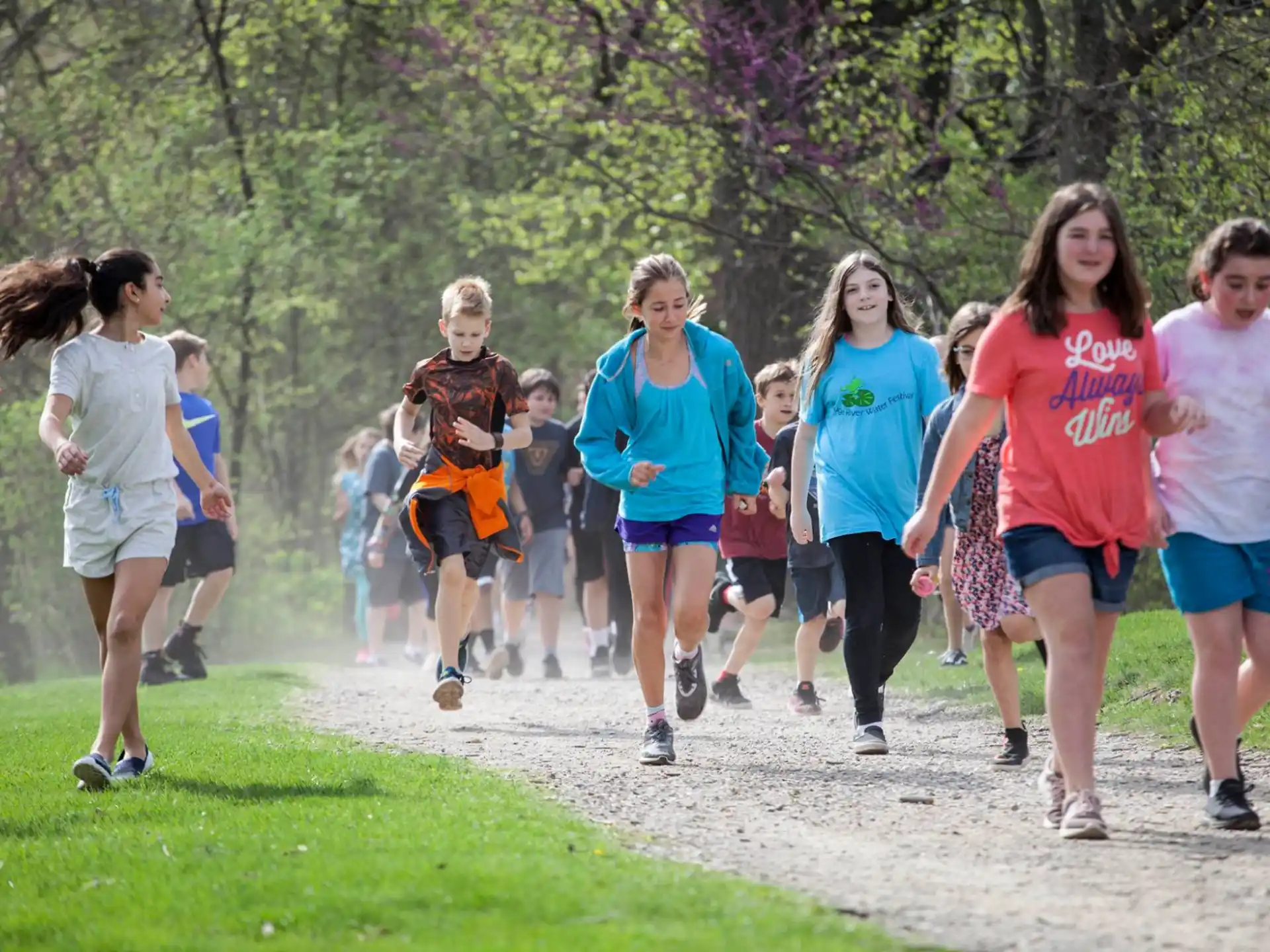 a group of people running on a path