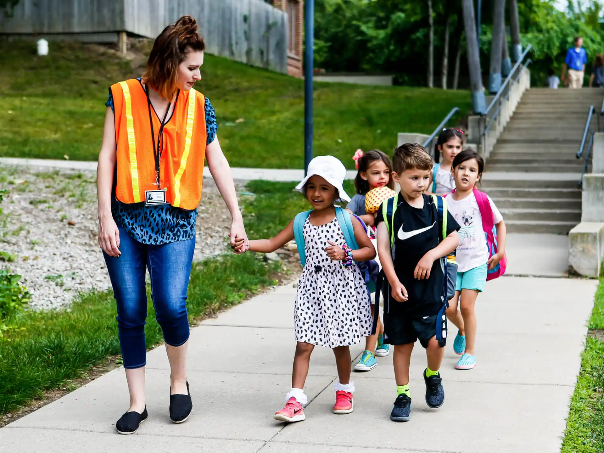 a person walking with a group of children