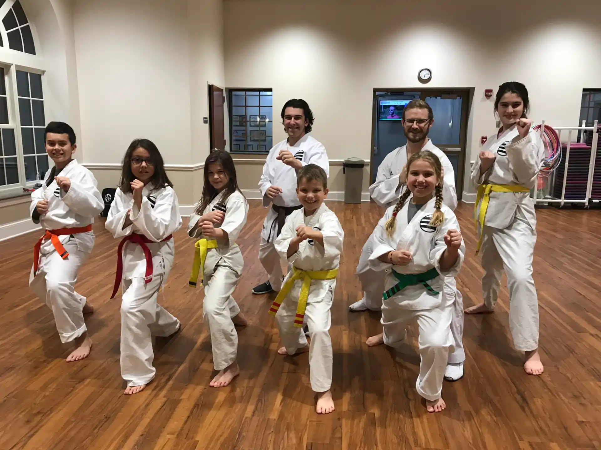 a group of people in karate uniforms