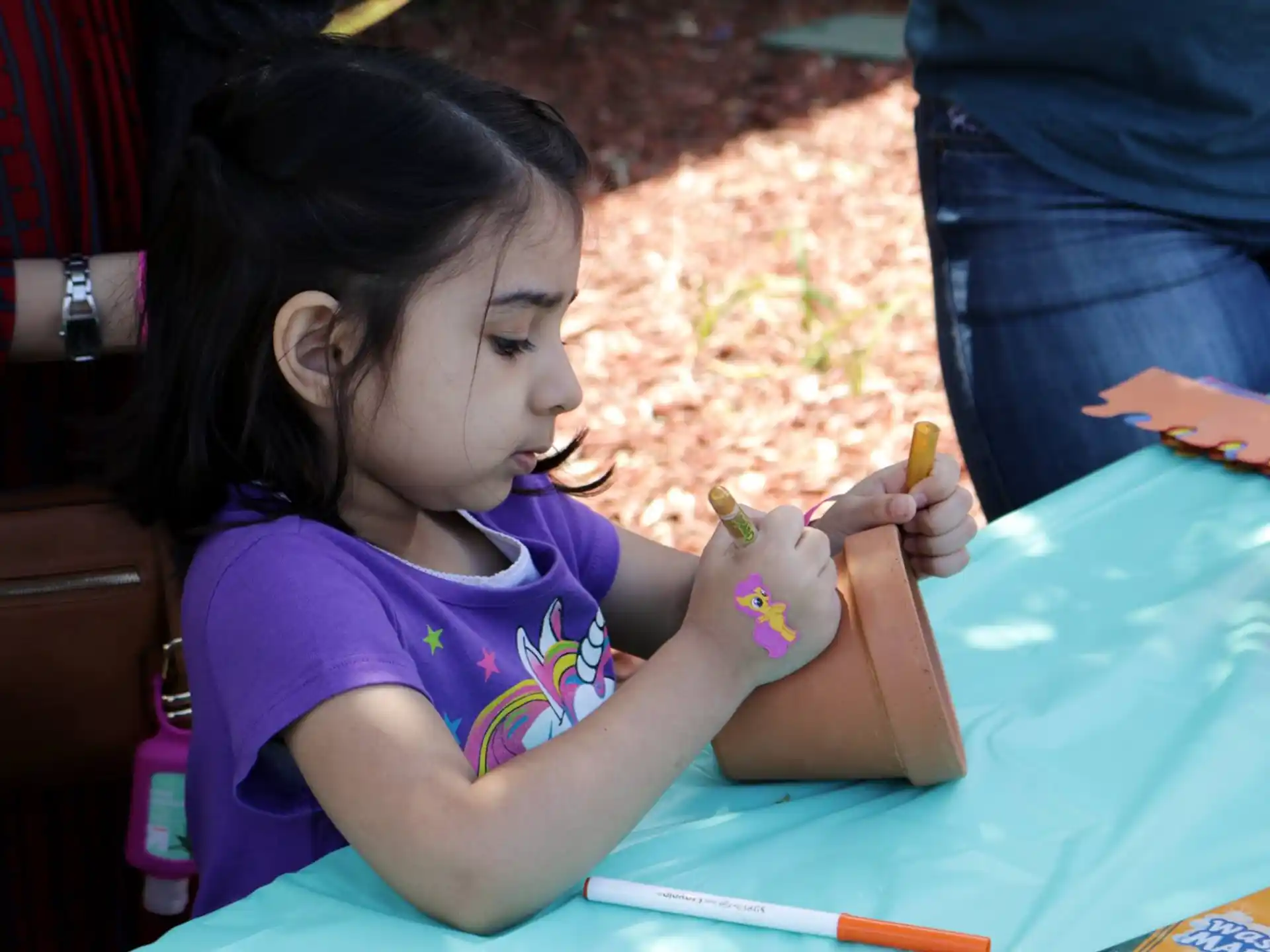 a girl painting on a table