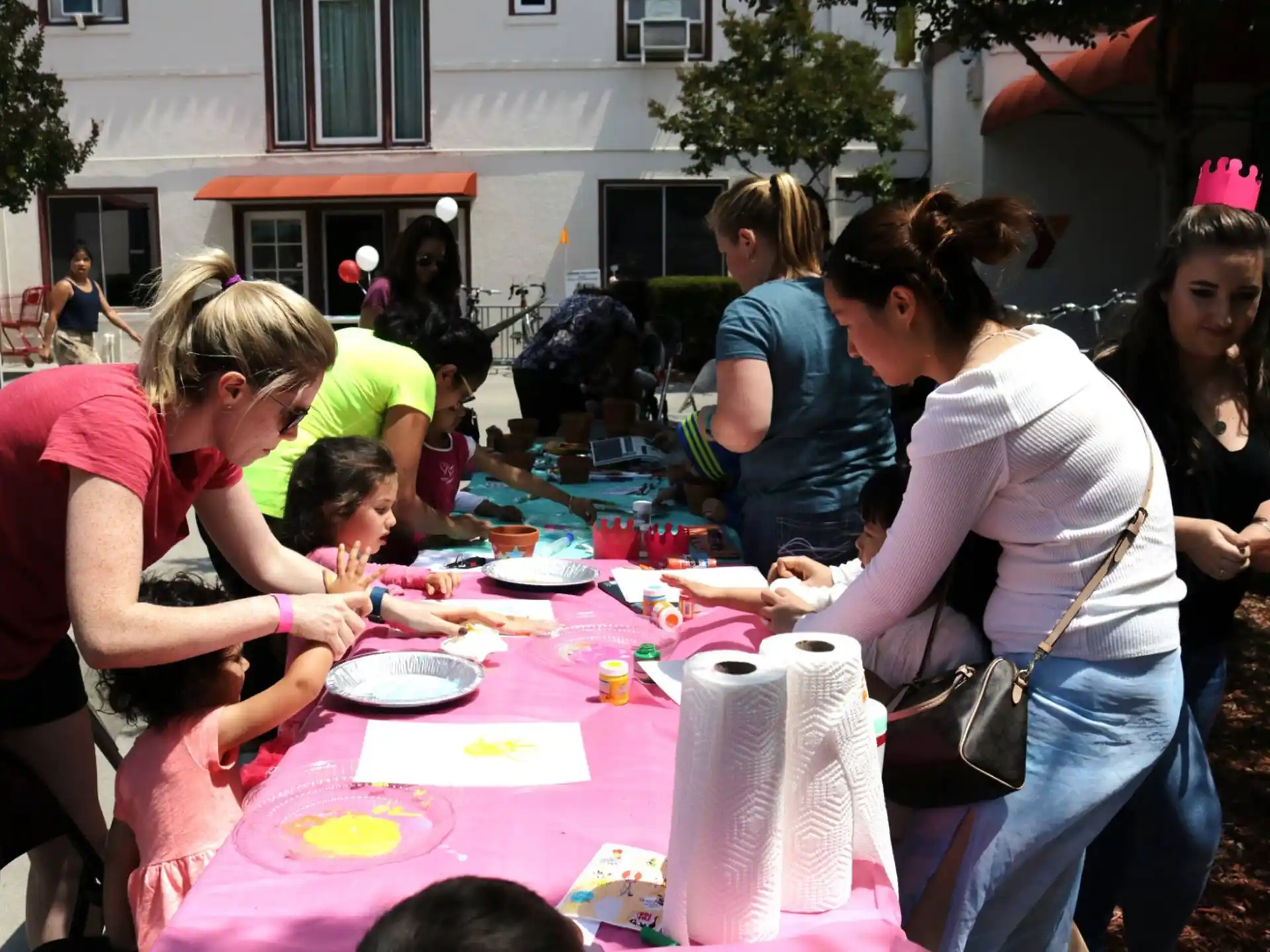 a group of people gathered around a table with food on it