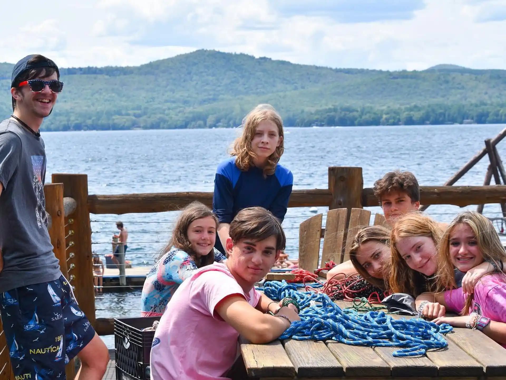 a group of people posing for a photo on a dock
