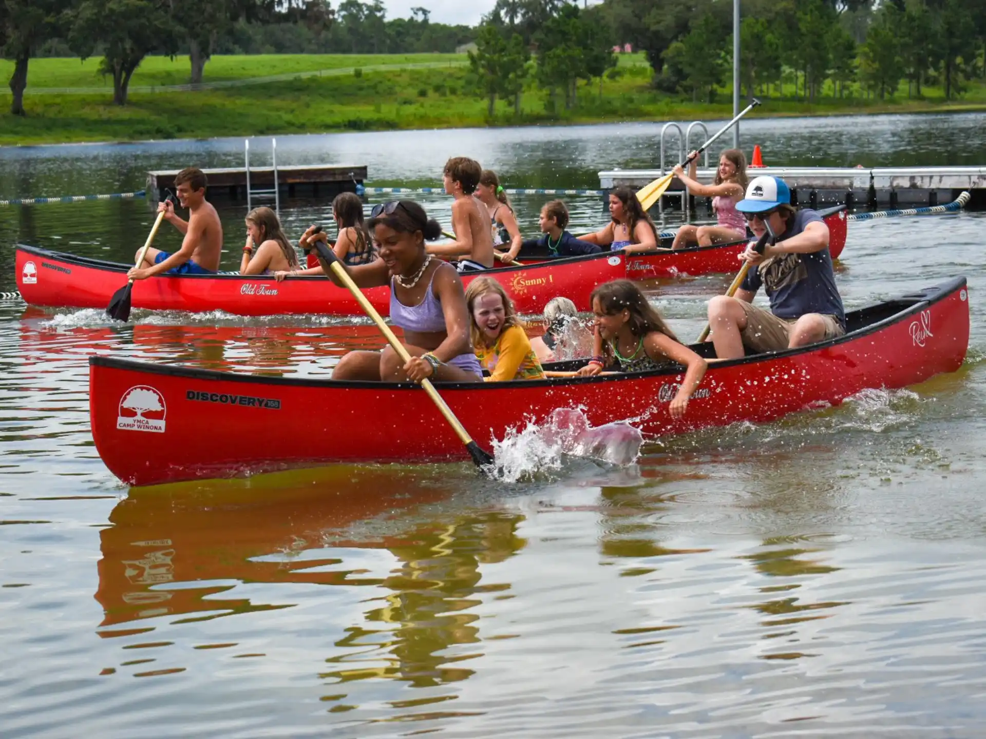 a group of people in a red canoe on a river