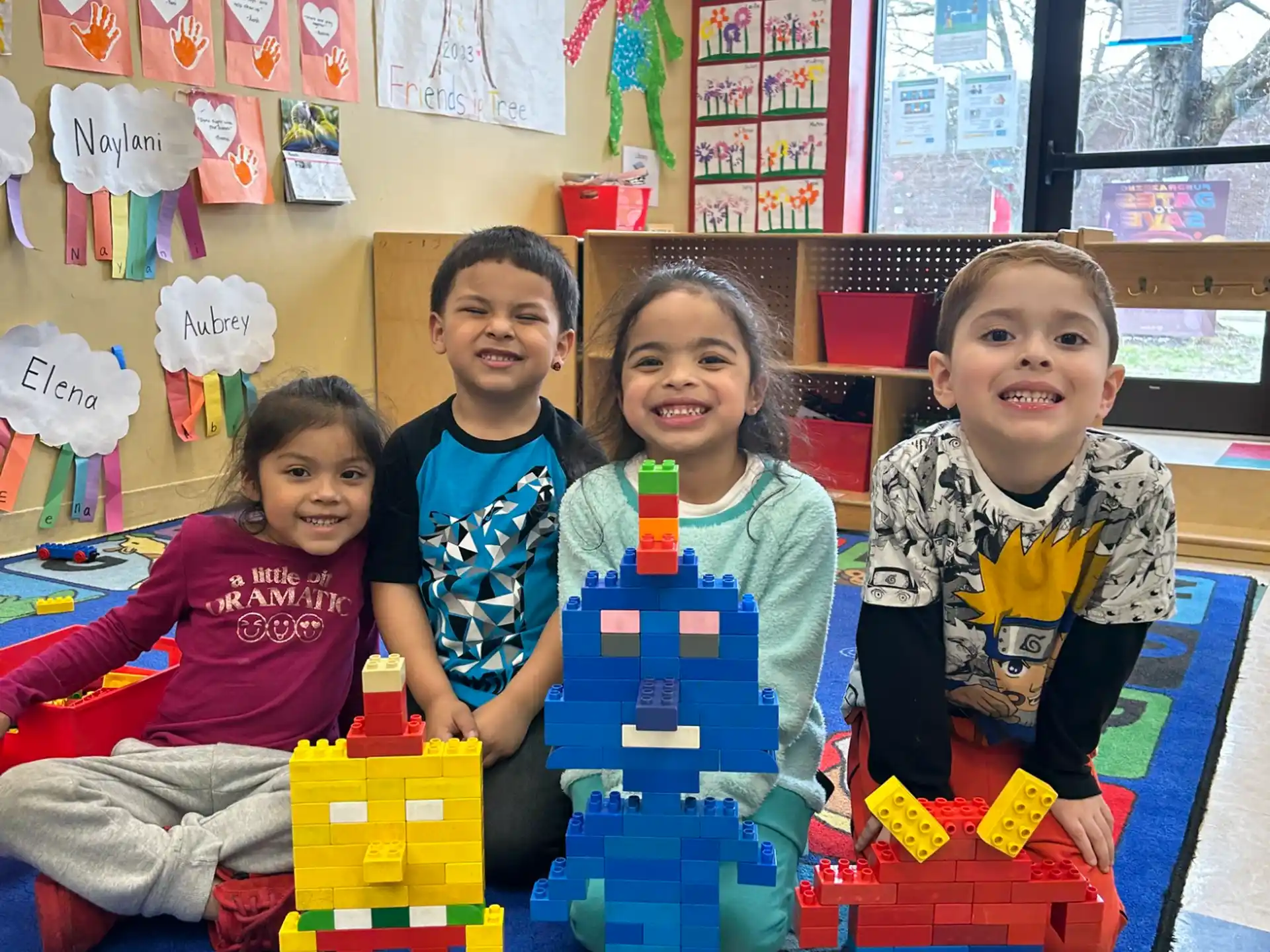 a group of children sitting on a colorful play set