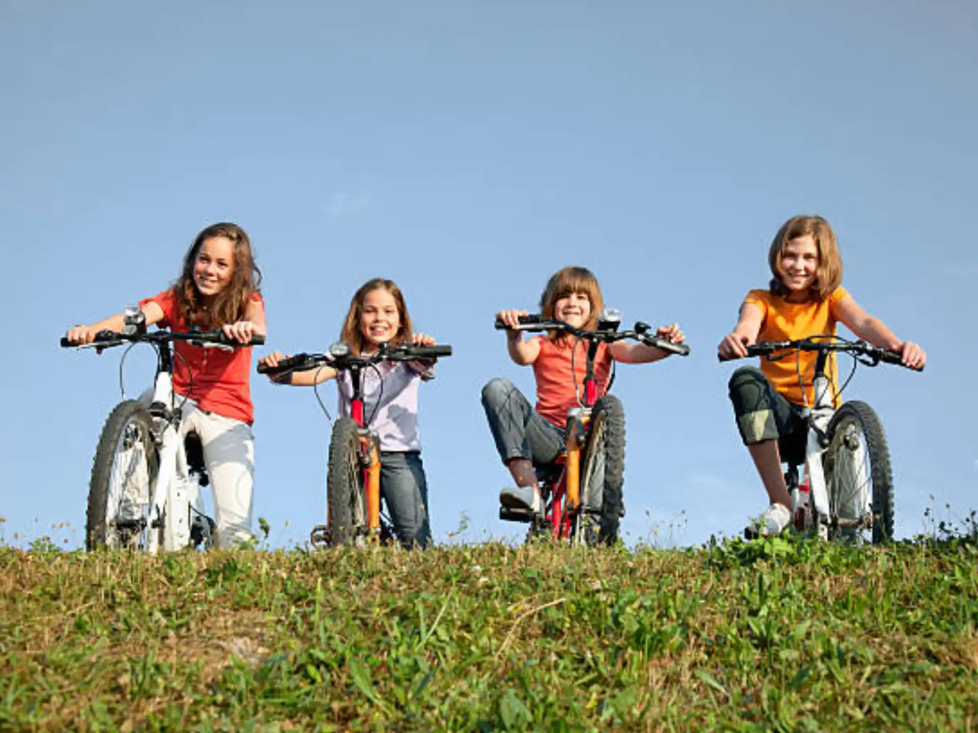 a group of kids on bicycles