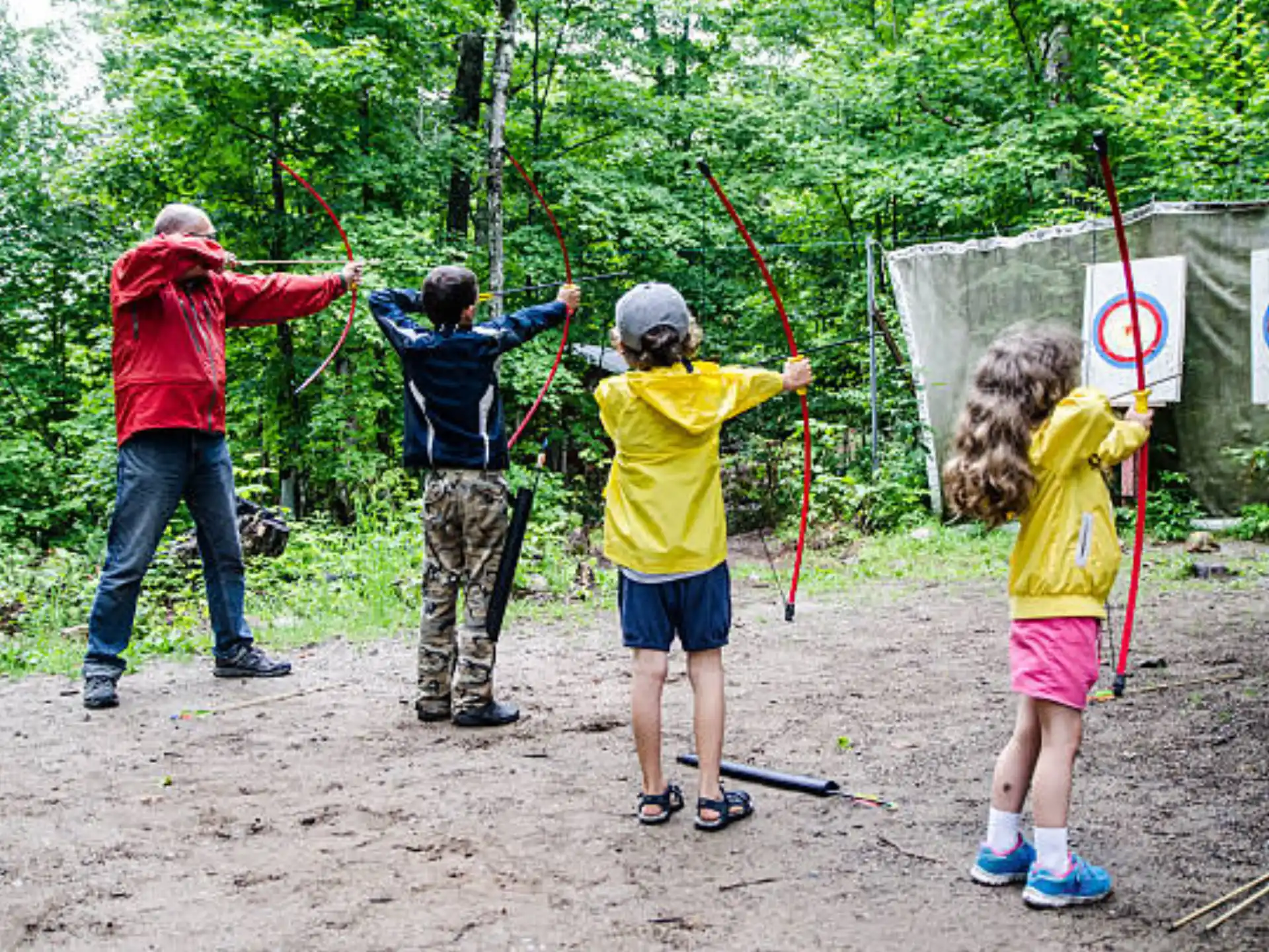 a group of people holding bows and arrows