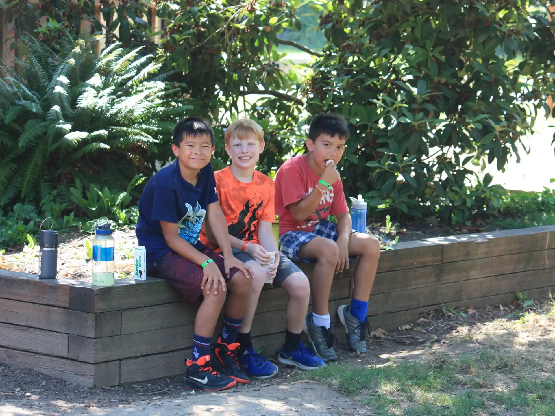 a group of boys sitting on a bench