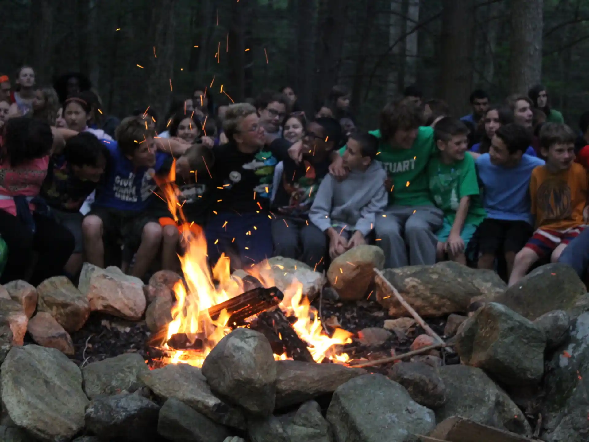a group of people sitting around a fire