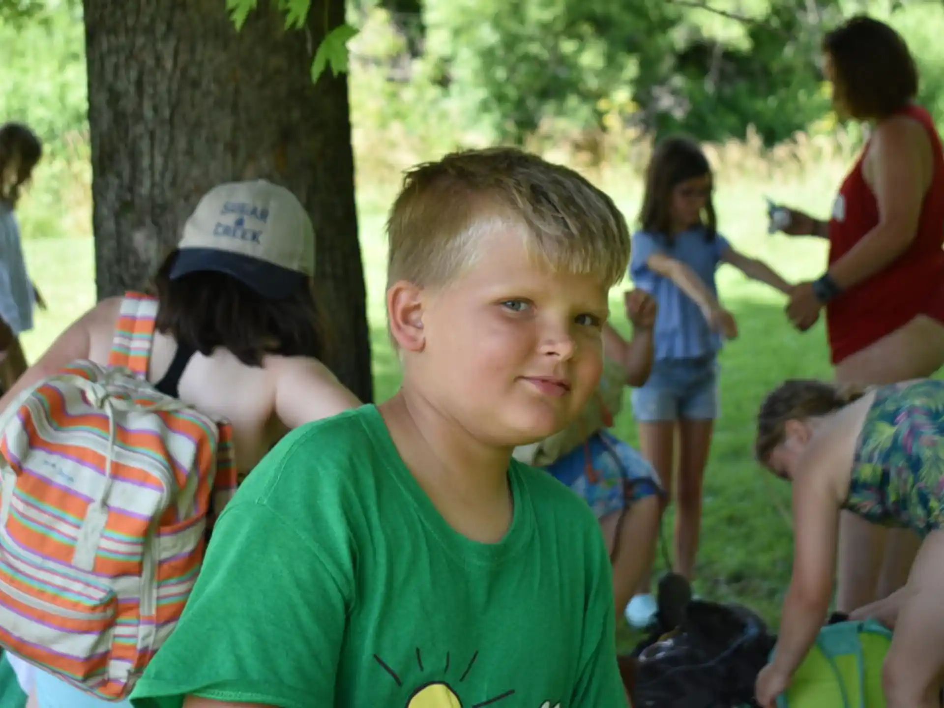 a boy in a green shirt