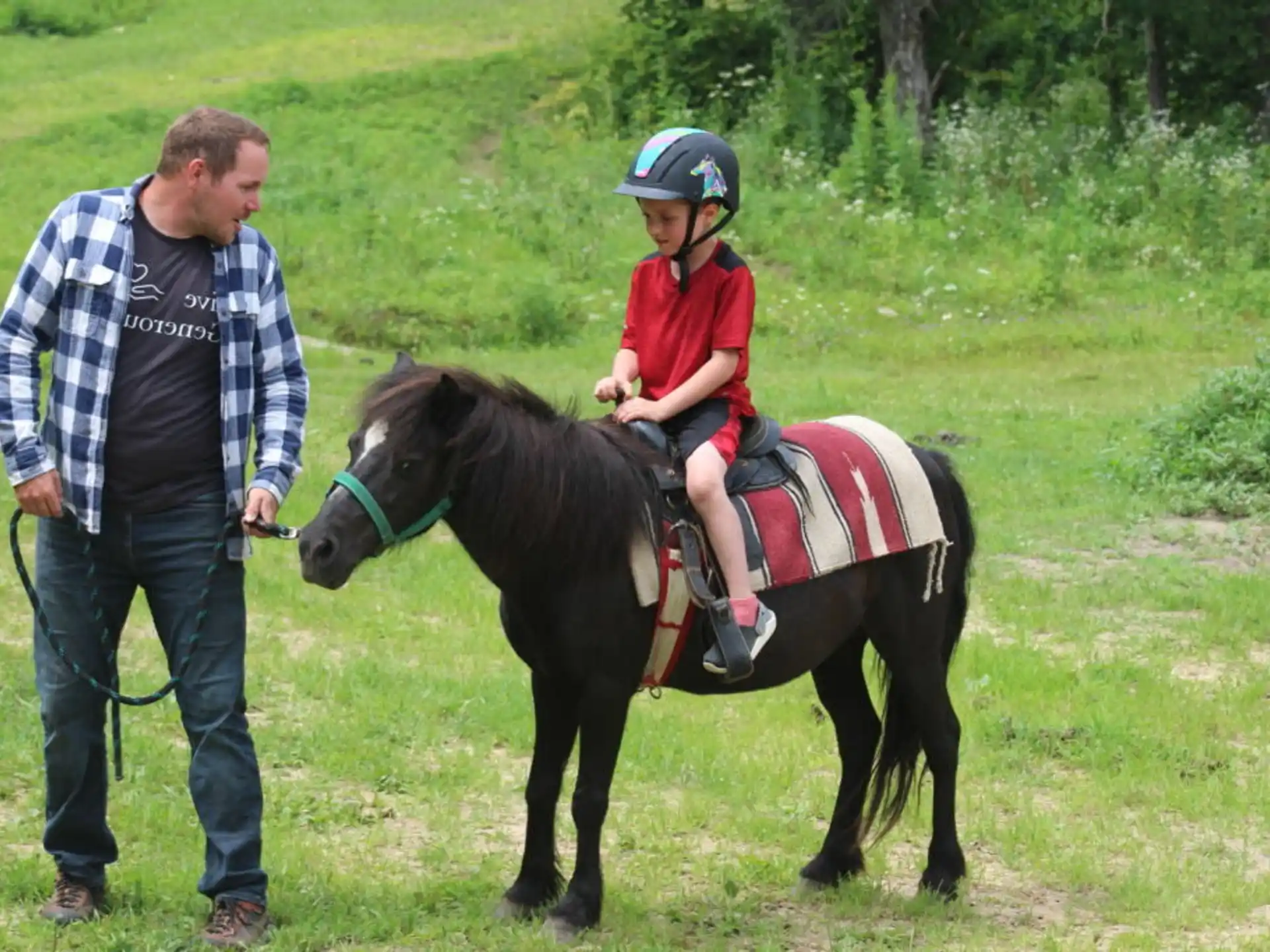 a man leading a child on a horse