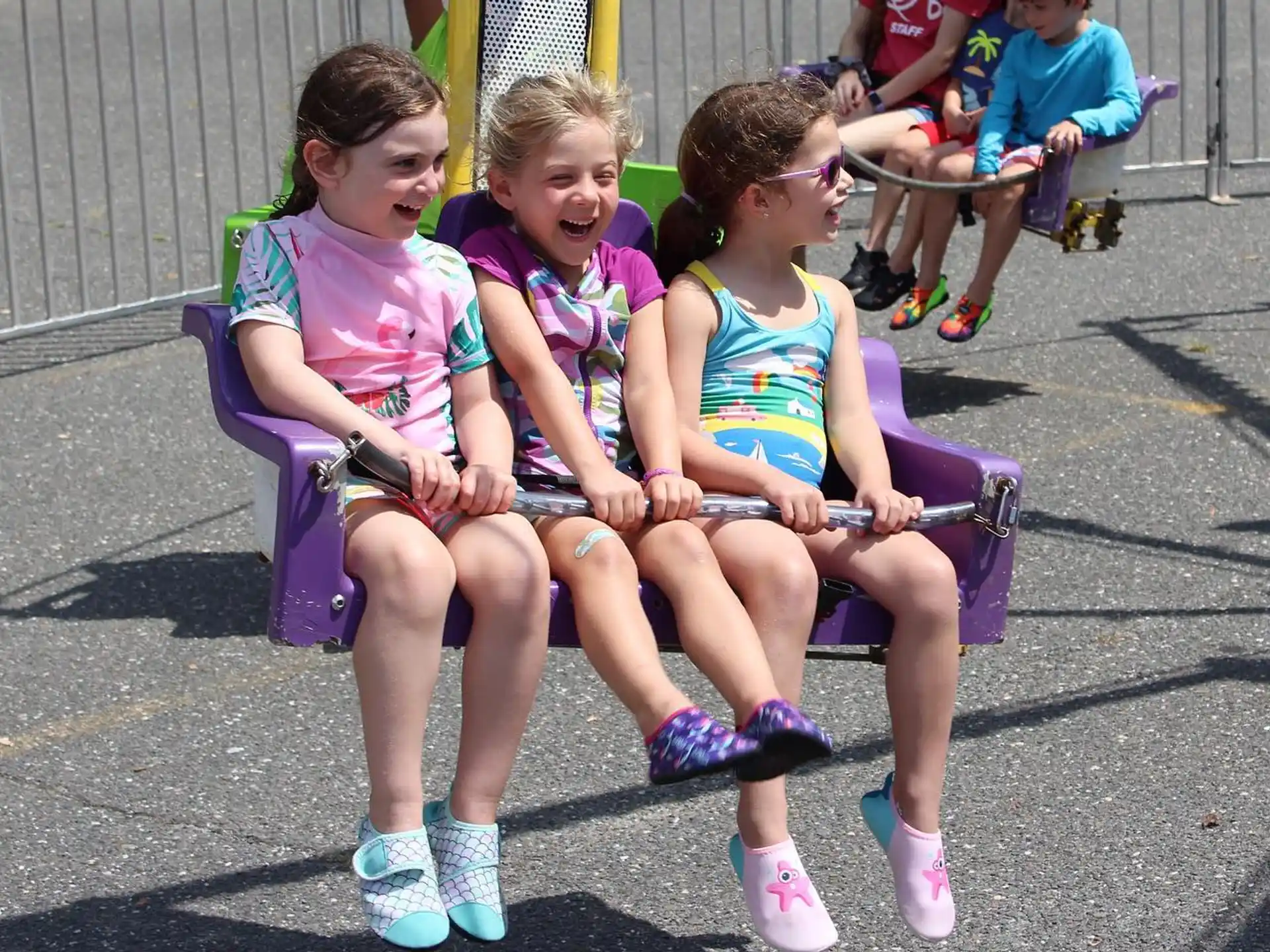 a group of girls sitting on a bench