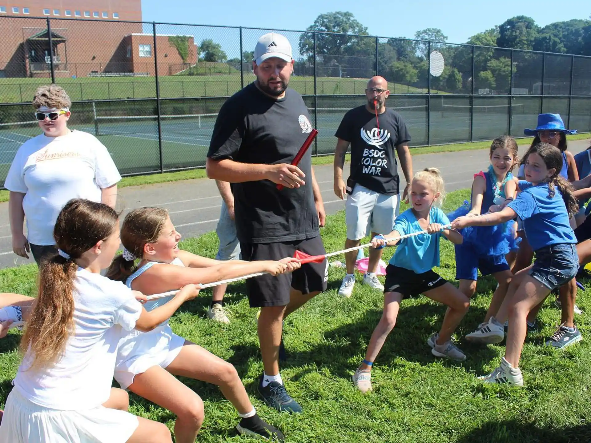 a group of people playing tug of war