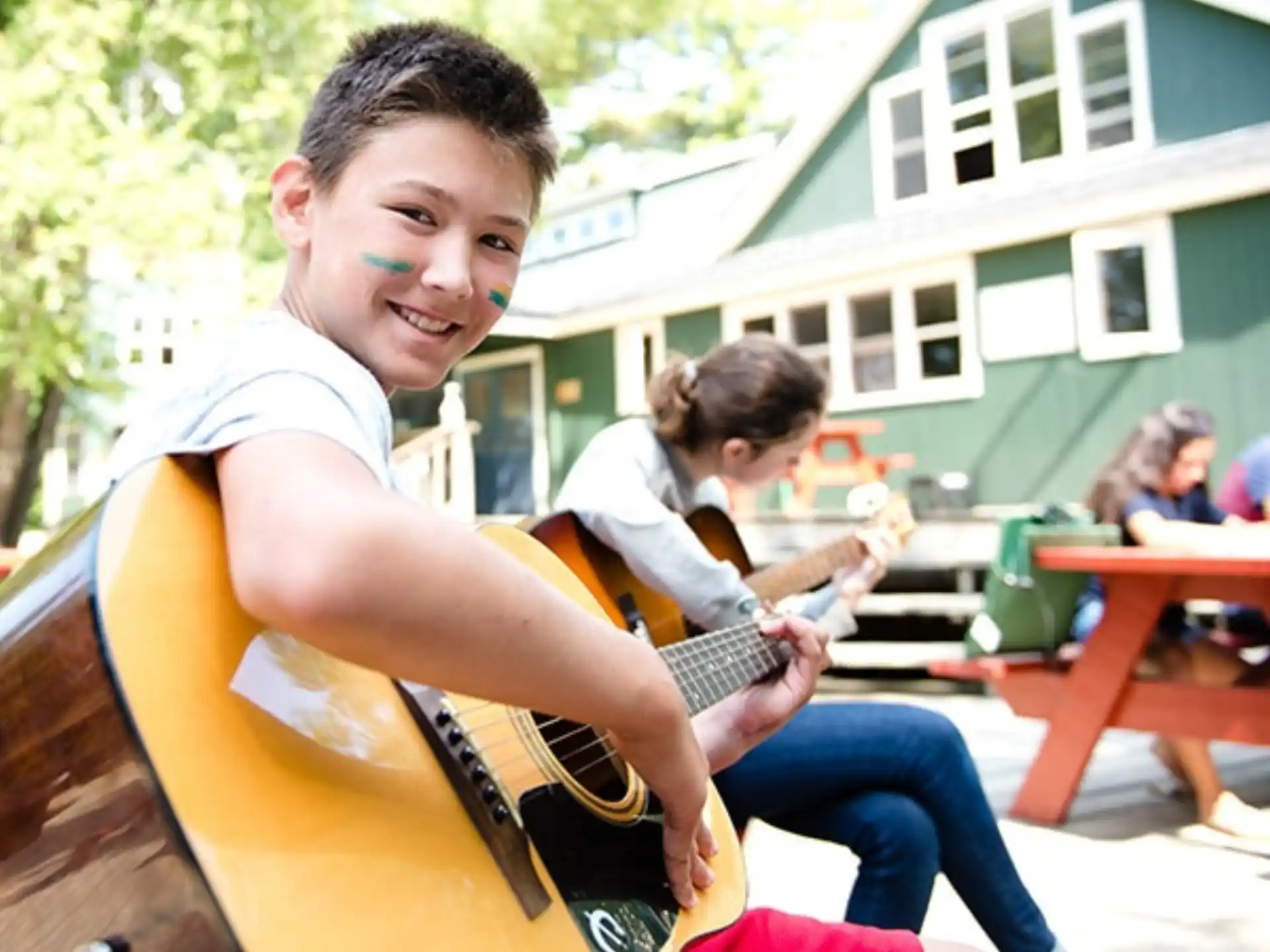 a boy playing a guitar