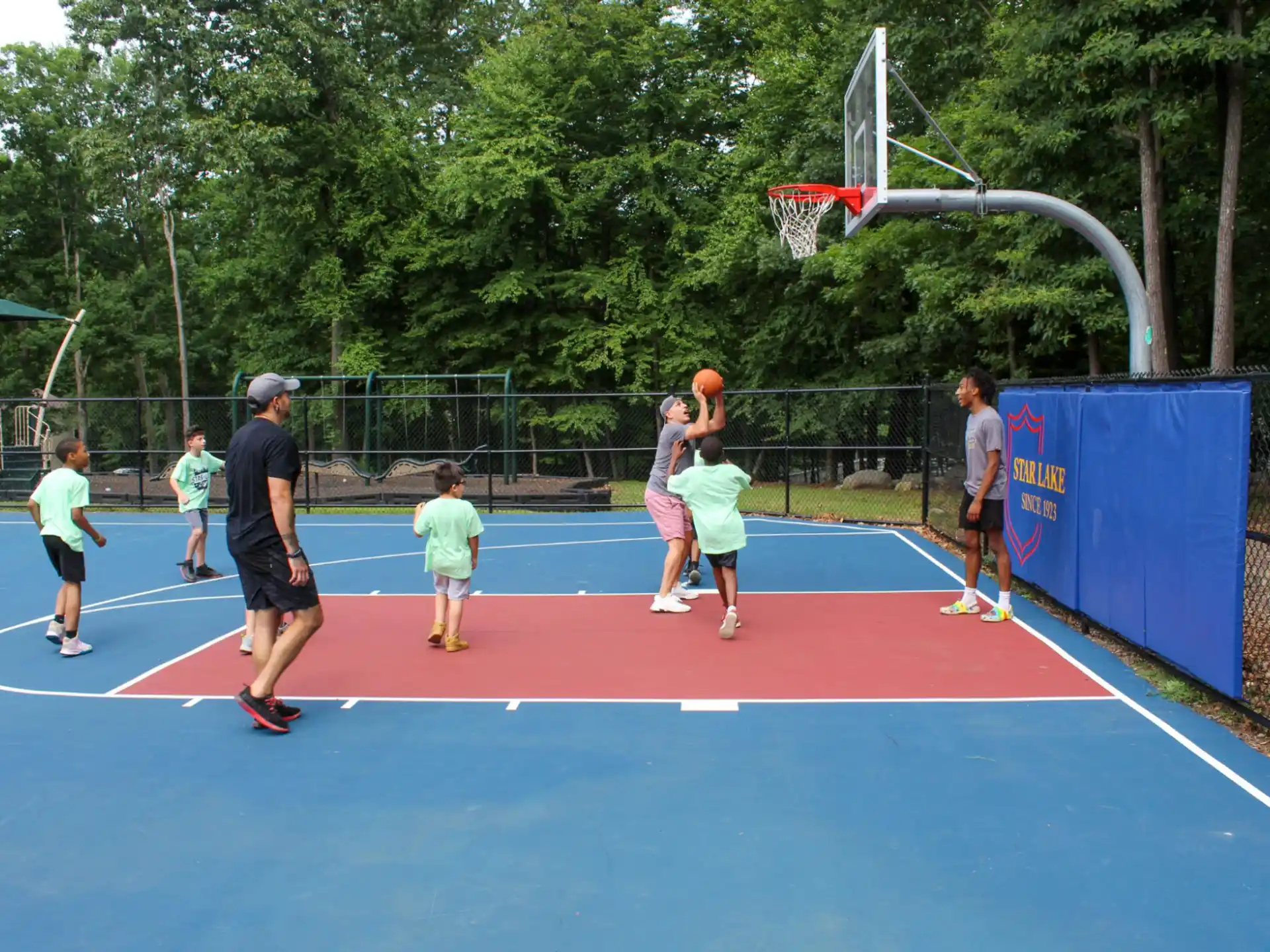 a group of people playing basketball