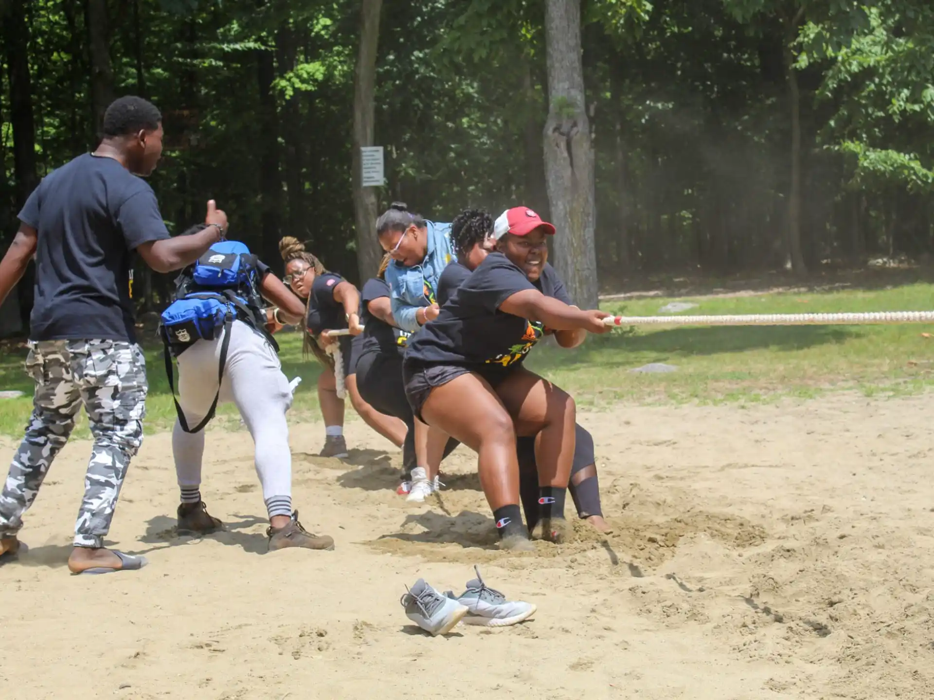 a group of people playing tug of war