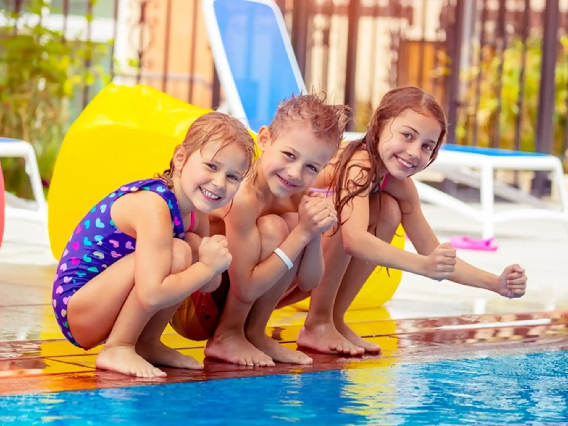 a group of girls in swimsuits in a pool