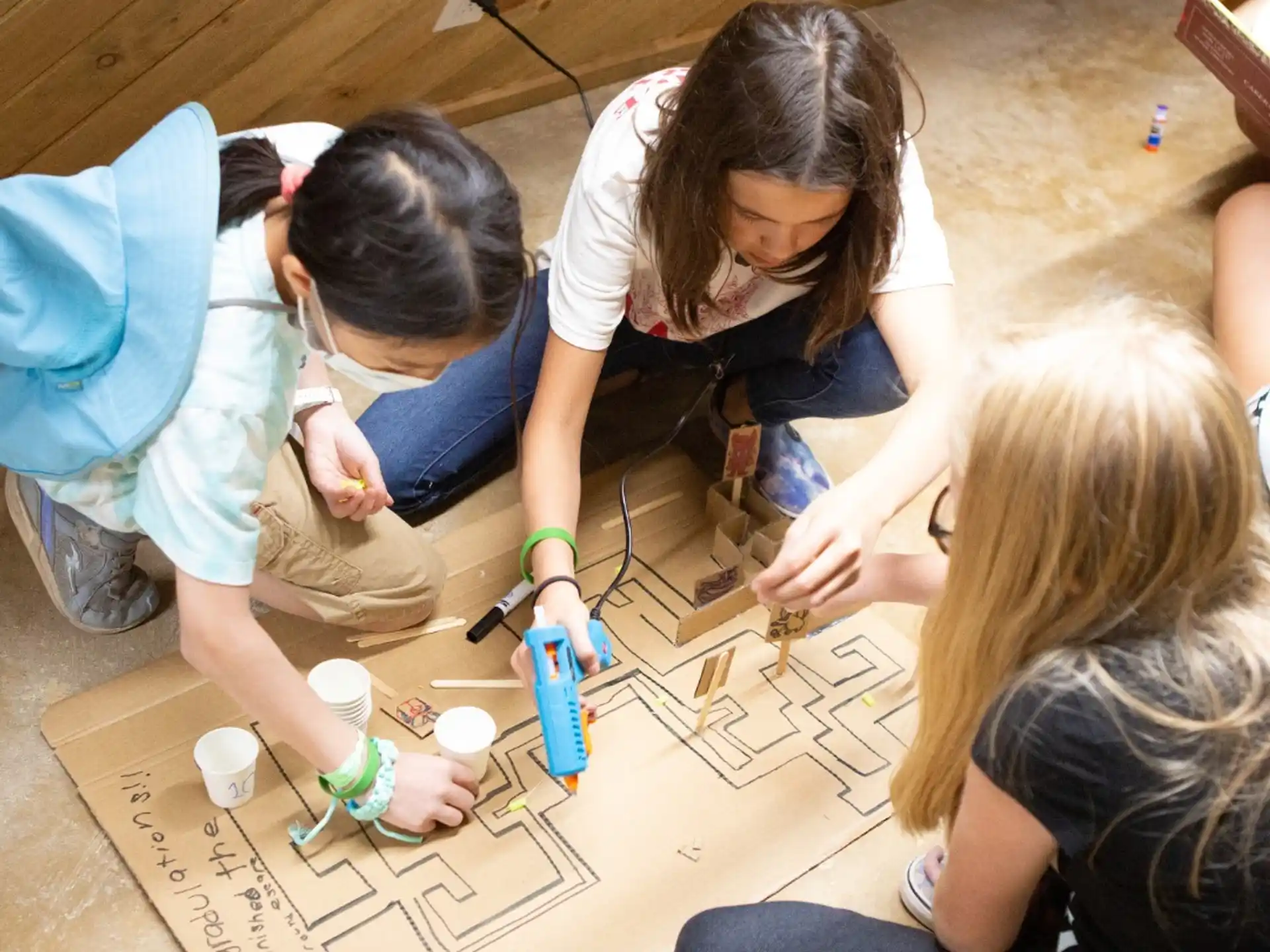 a group of girls doing crafts