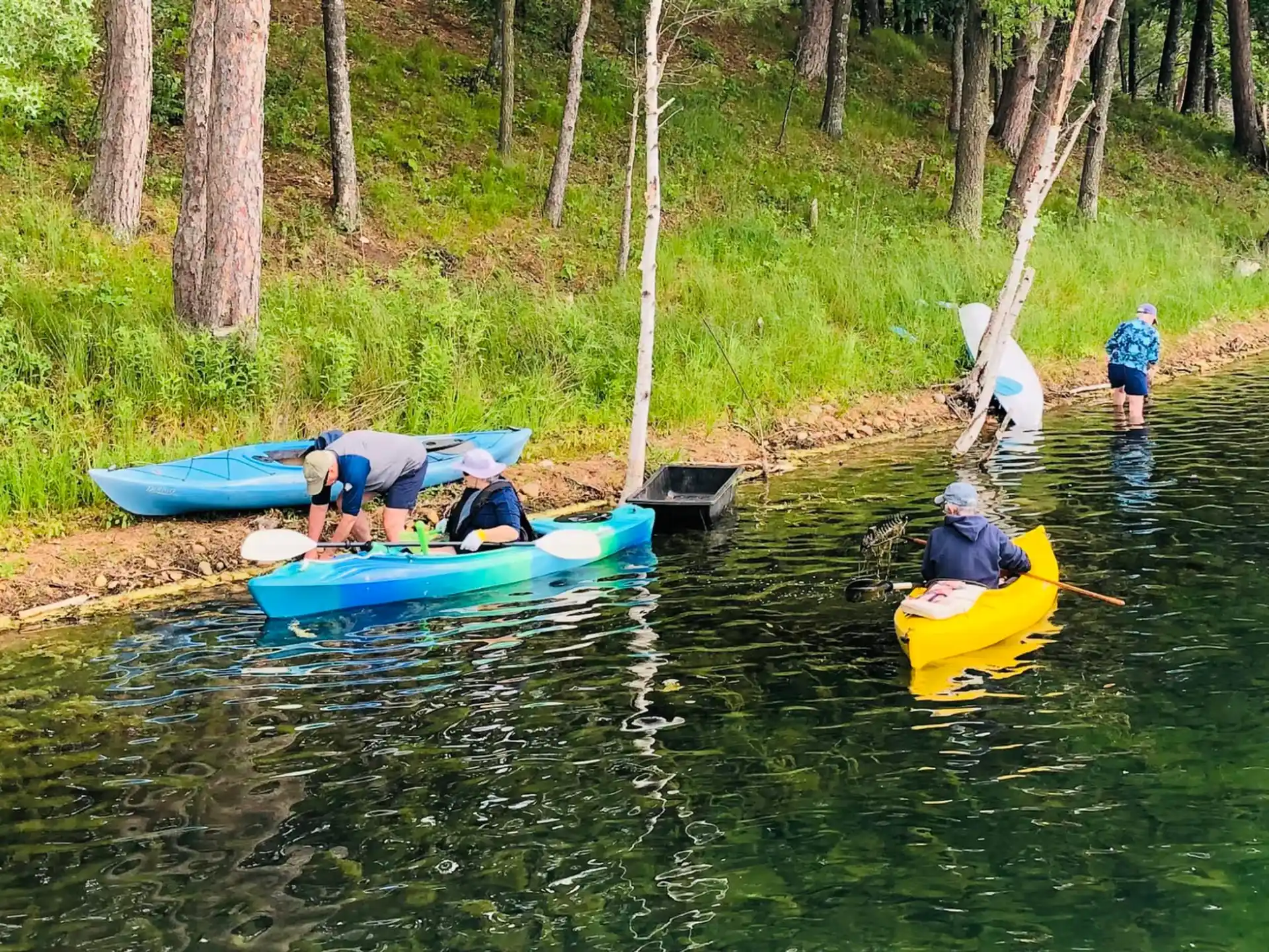 people in kayaks on a river