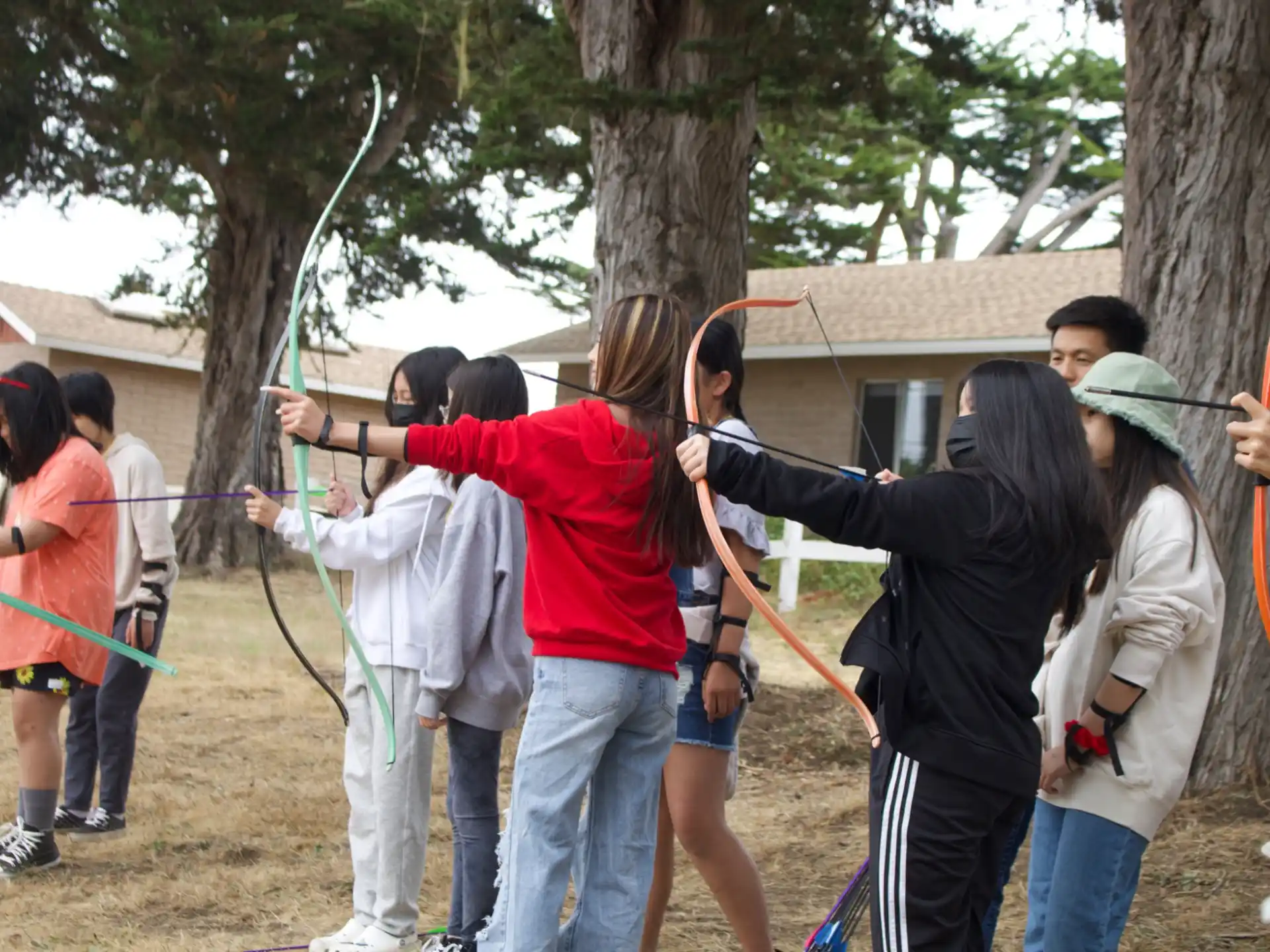 a group of people holding onto a tree