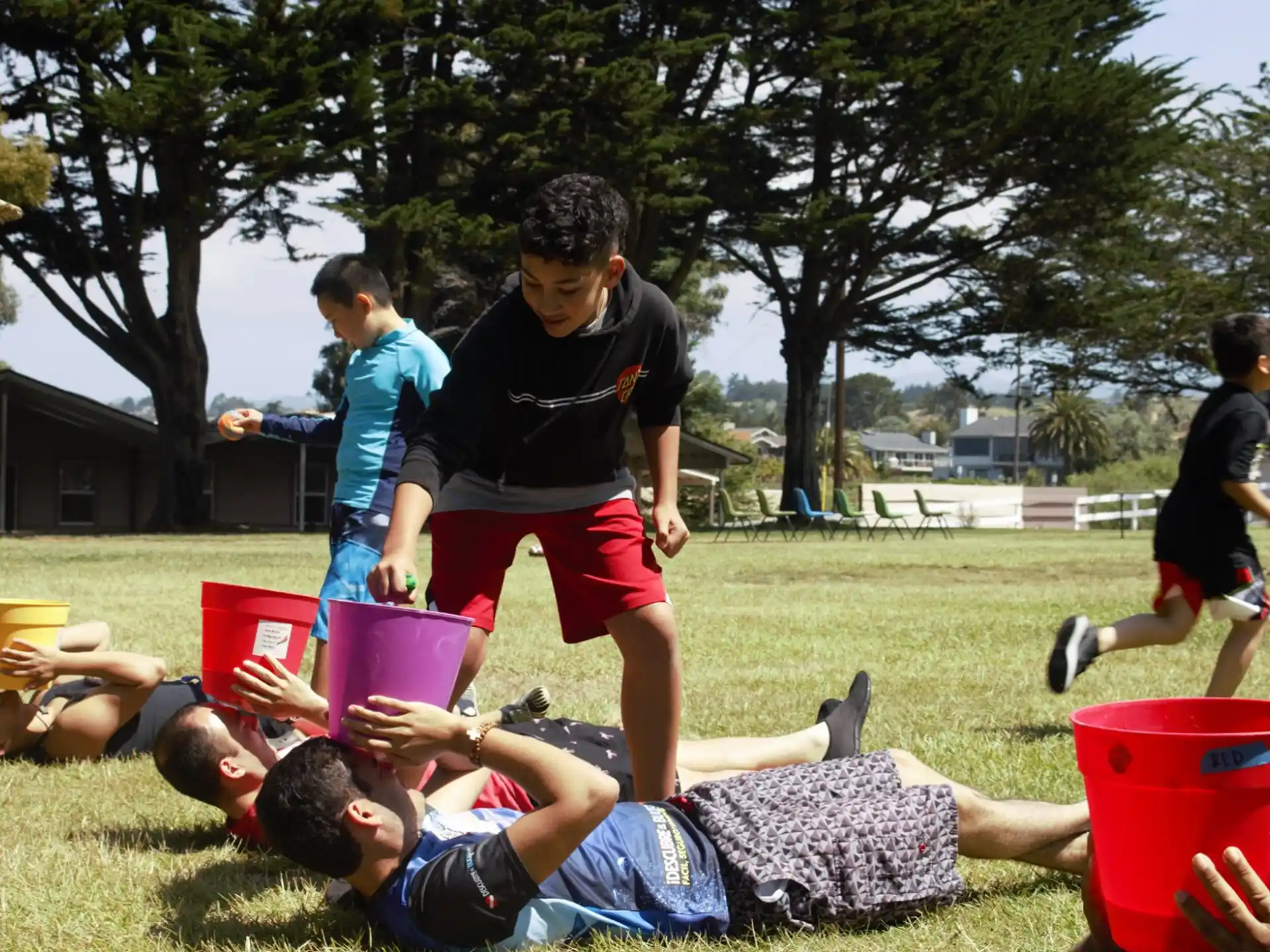 a group of people playing with buckets