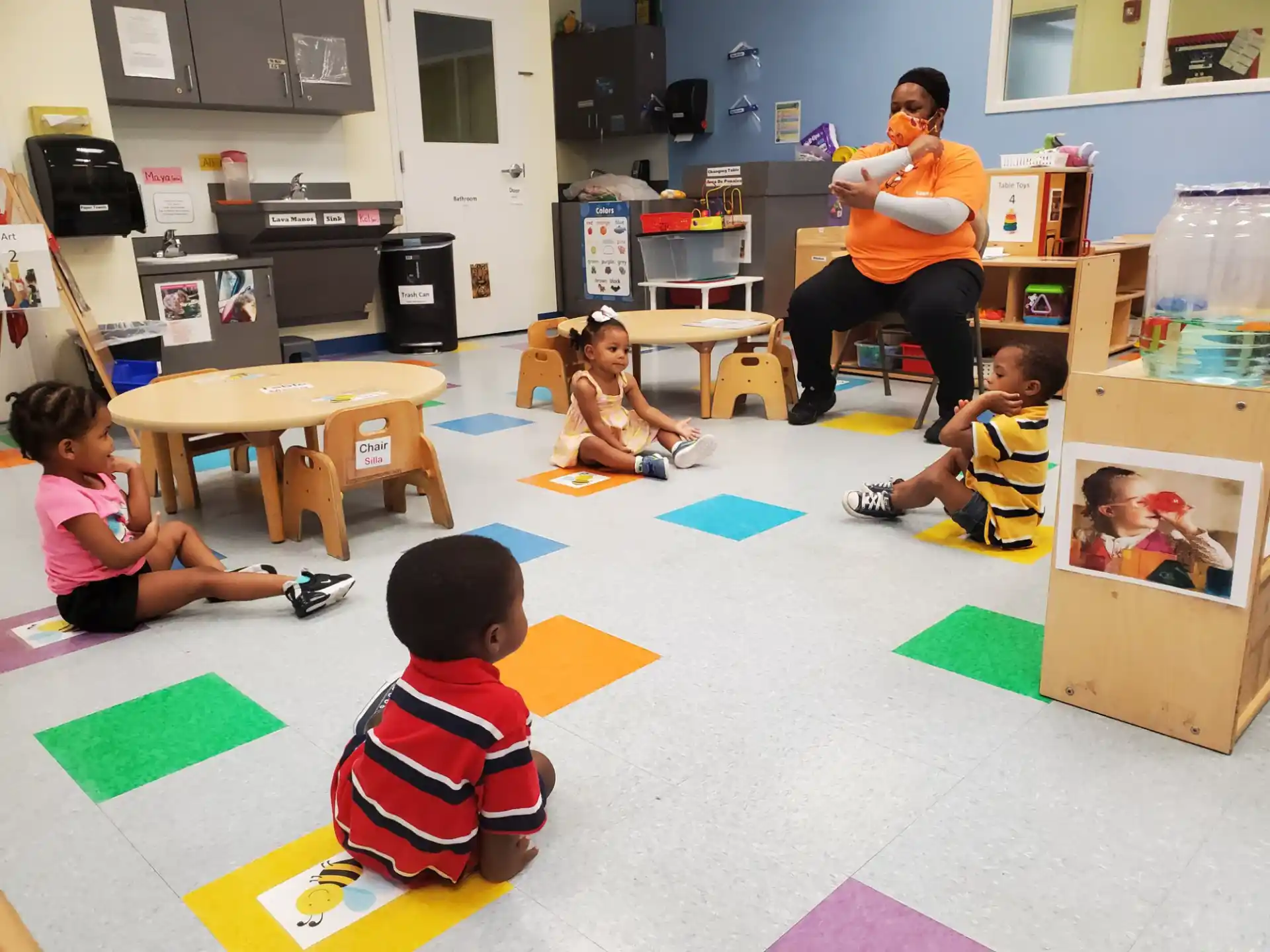 a person and children in a classroom