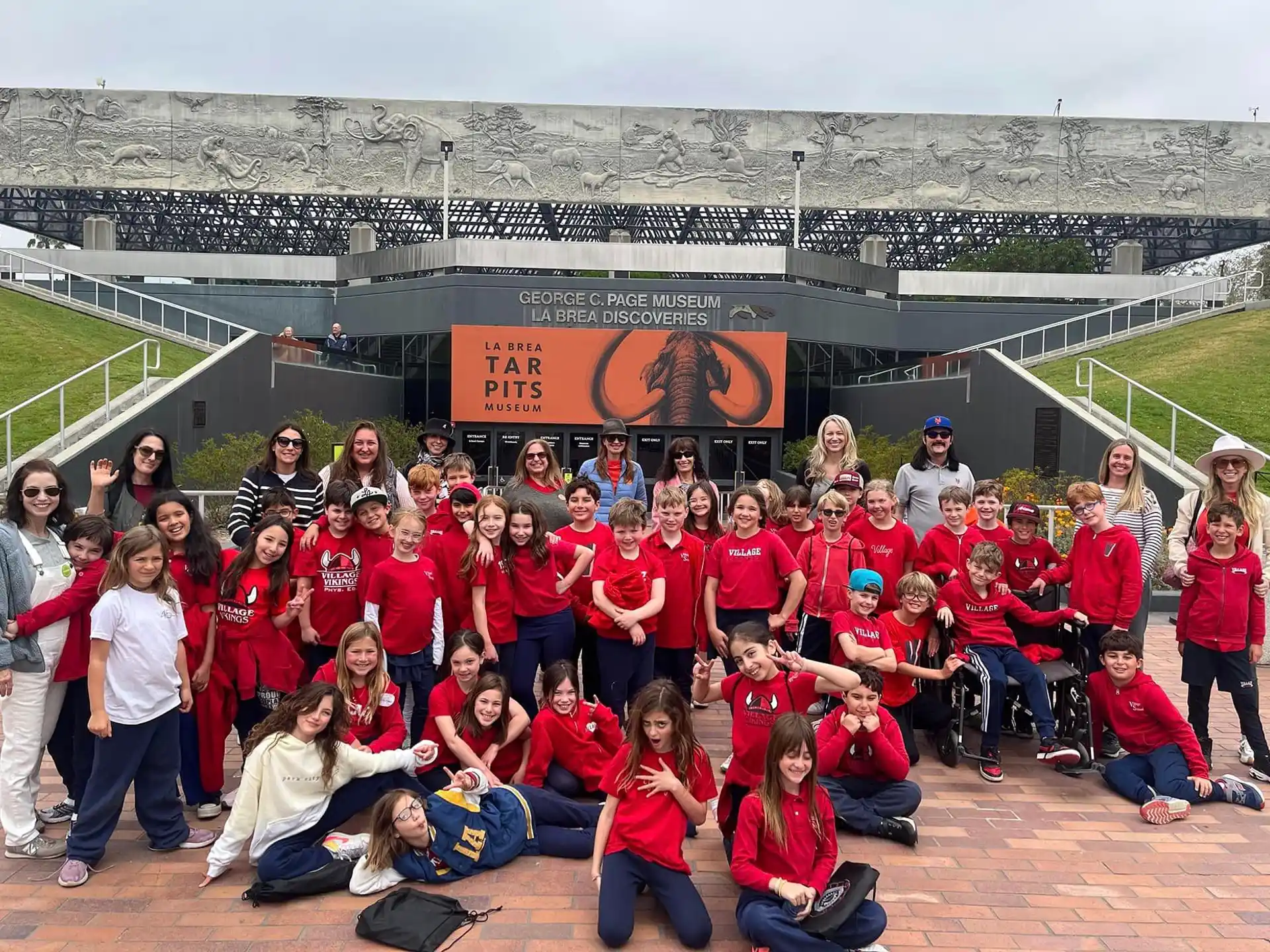 a group of people posing for a photo in front of a stadium