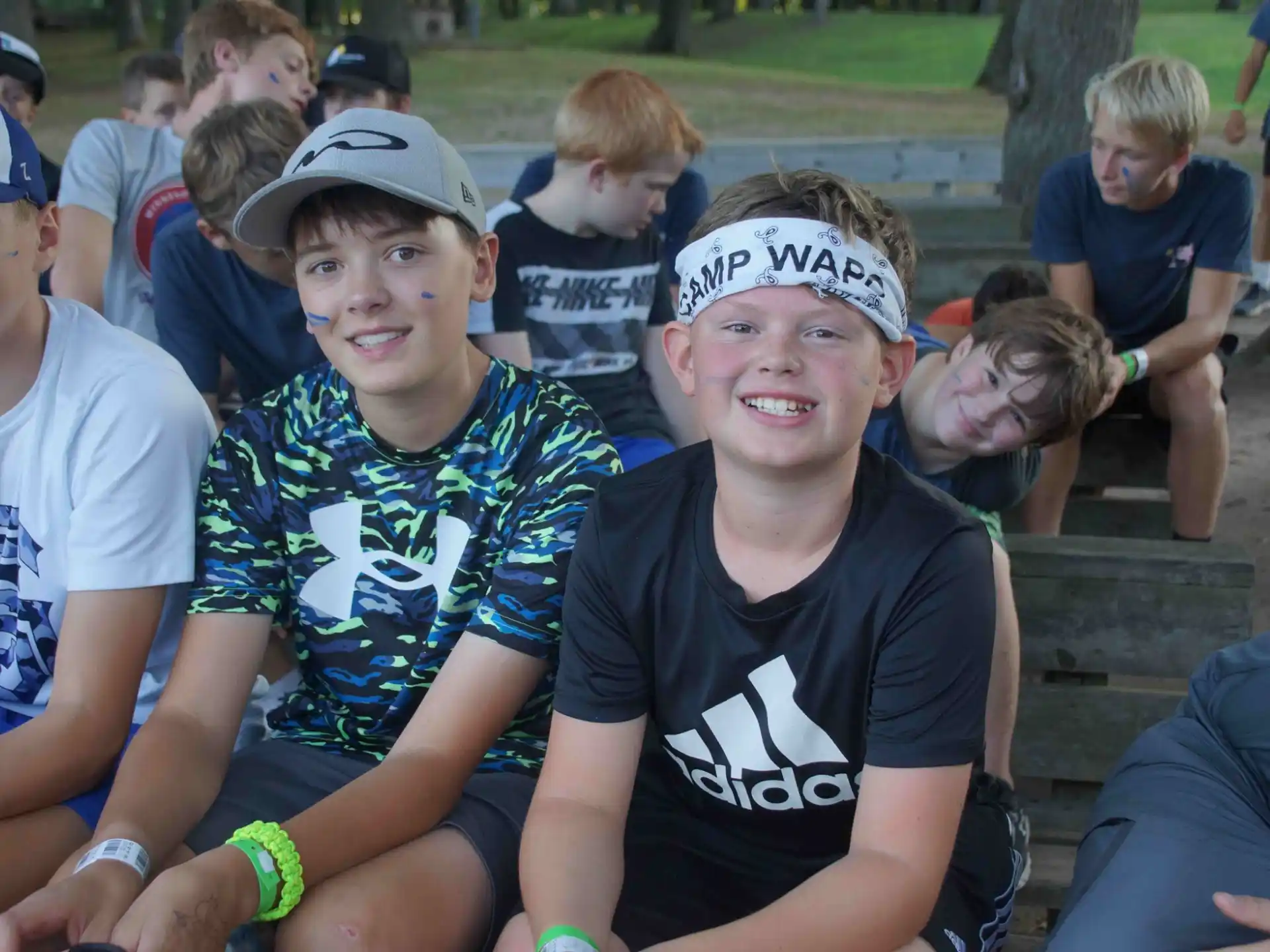 a group of boys sitting on a bench