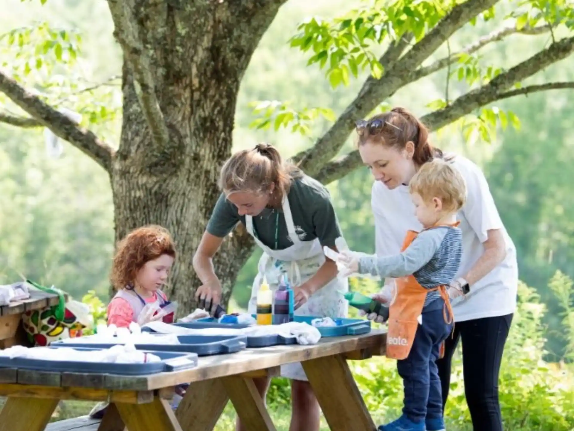 a group of people around a picnic table