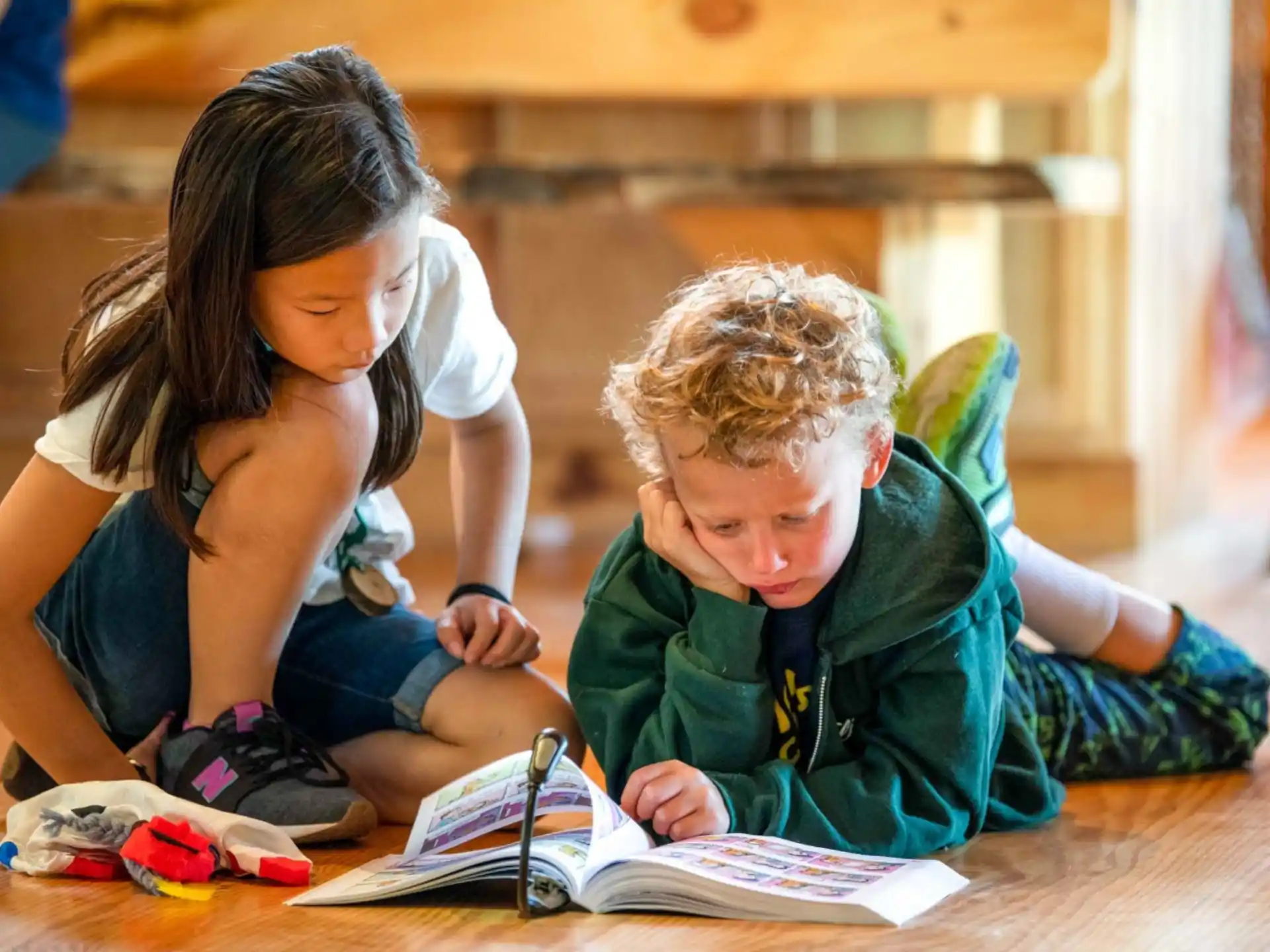 a young boy and girl reading a book