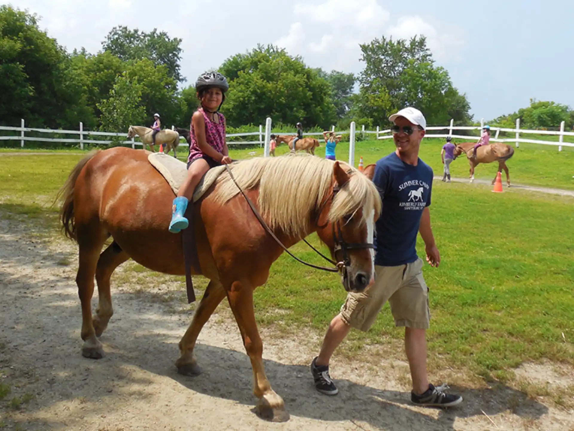 a person and a child riding a horse