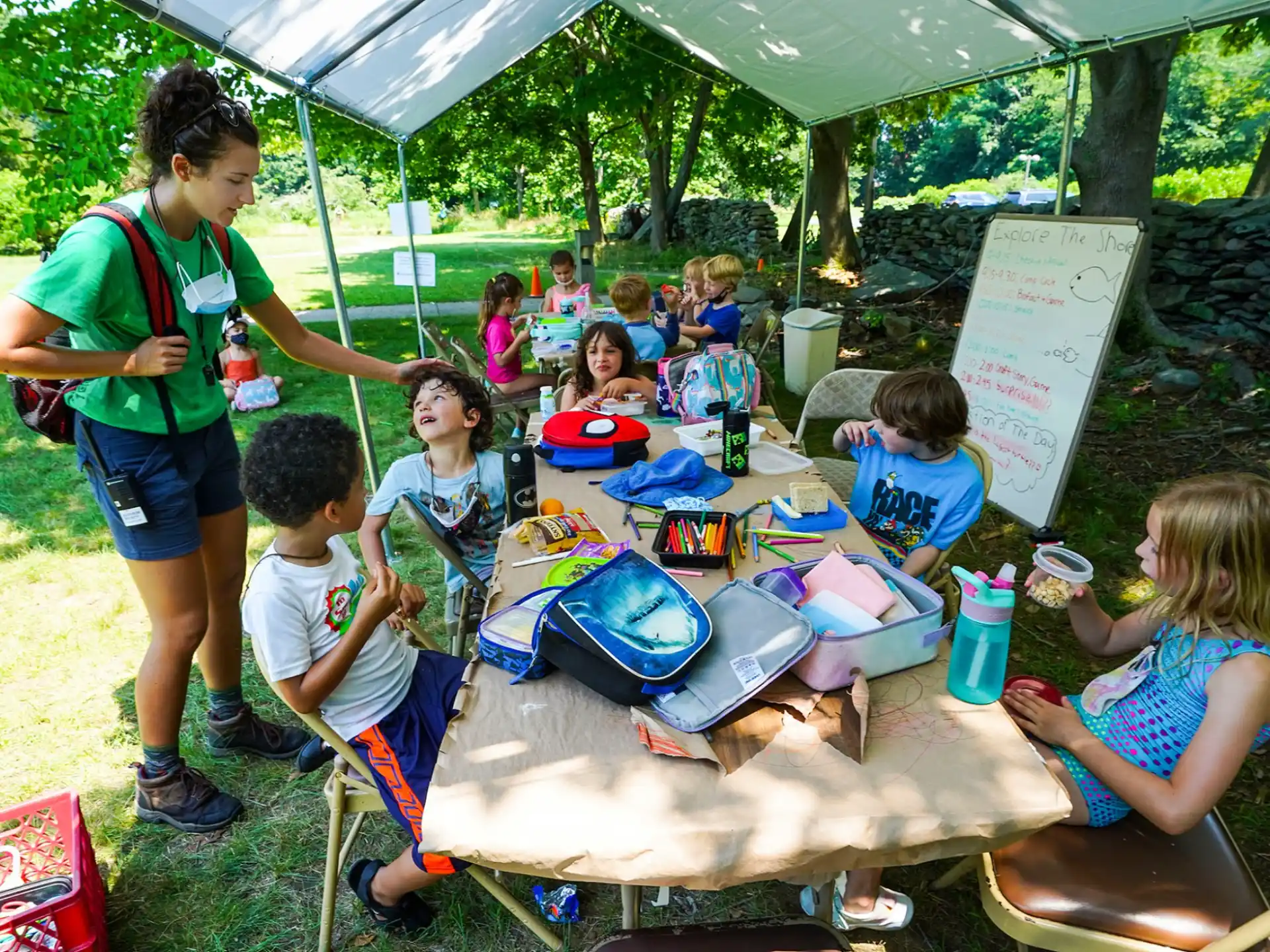 a person and kids at a picnic table