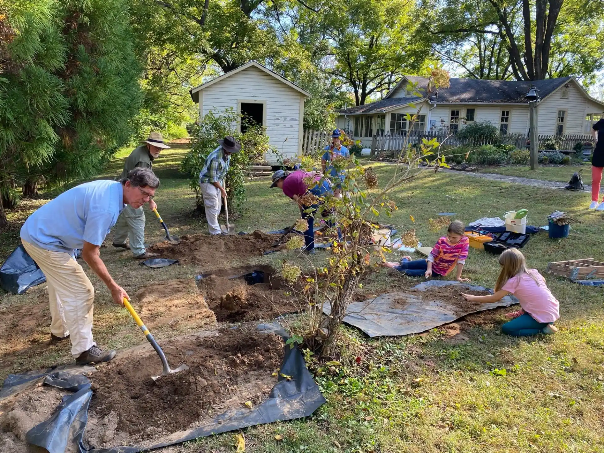 a group of people digging in the dirt