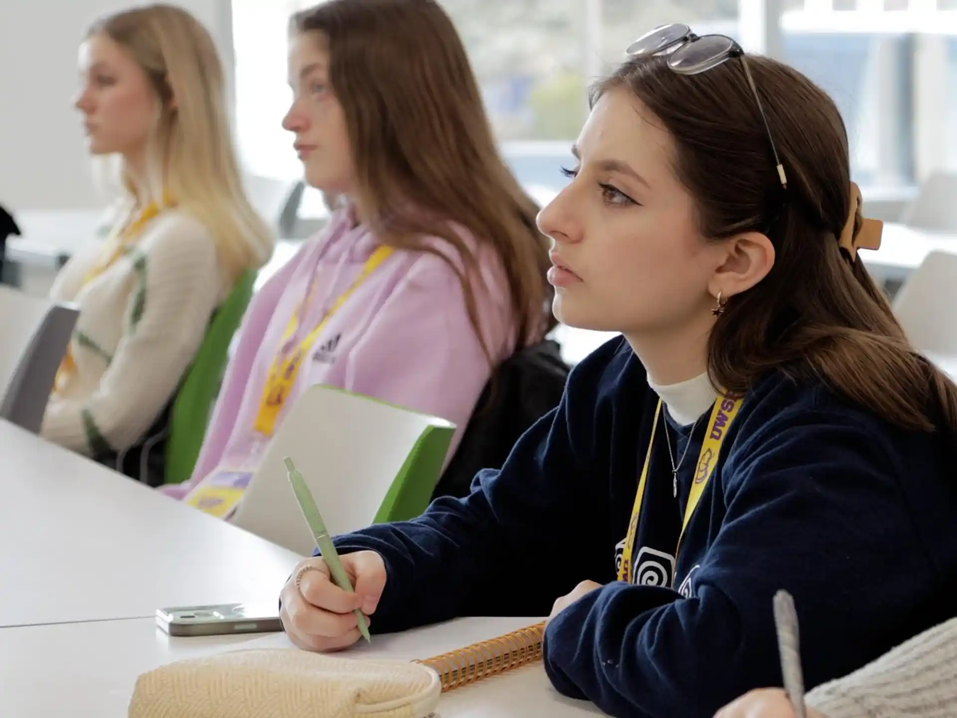 a young girl writing on a piece of paper