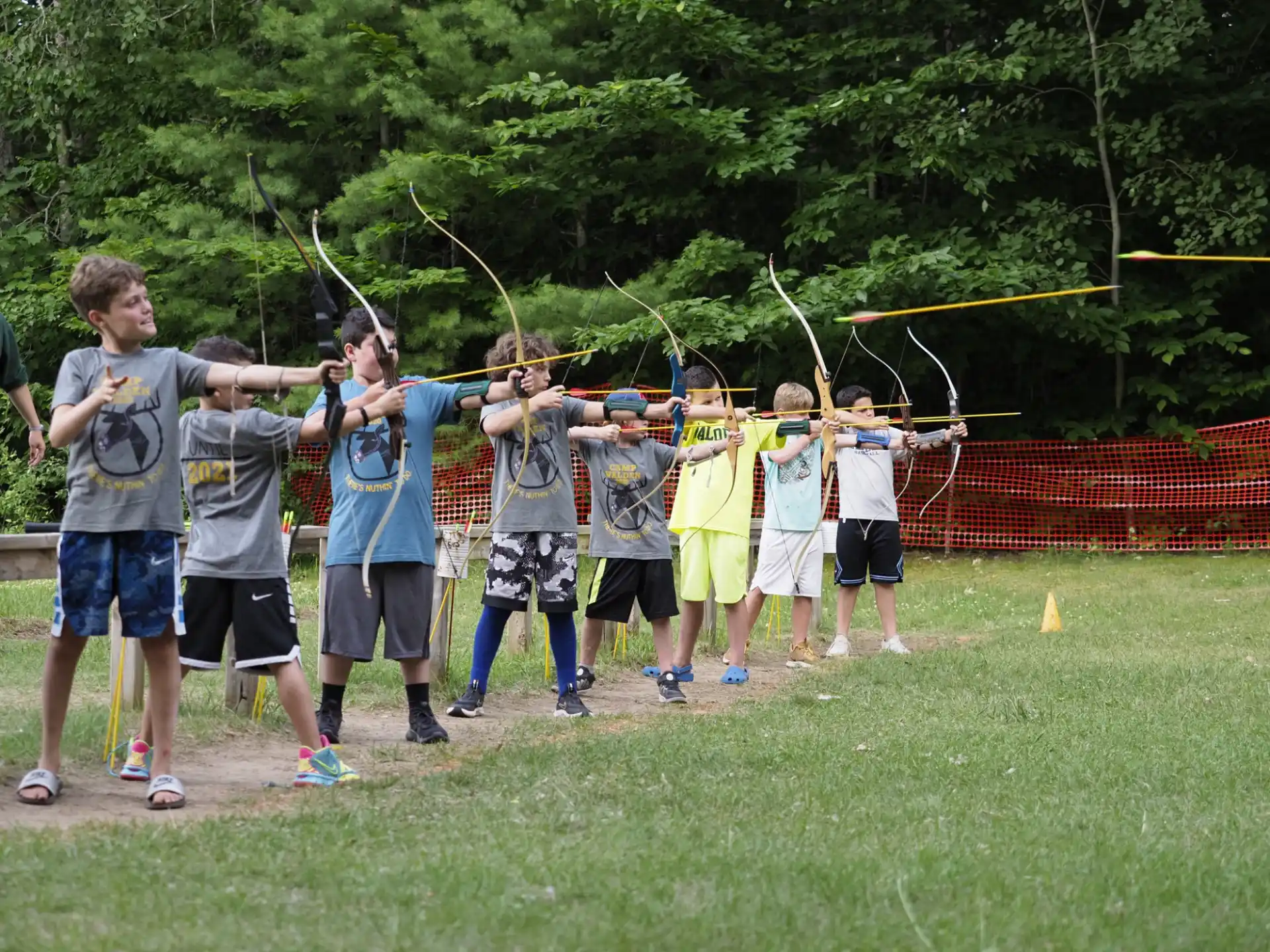 a group of people holding bows and arrows