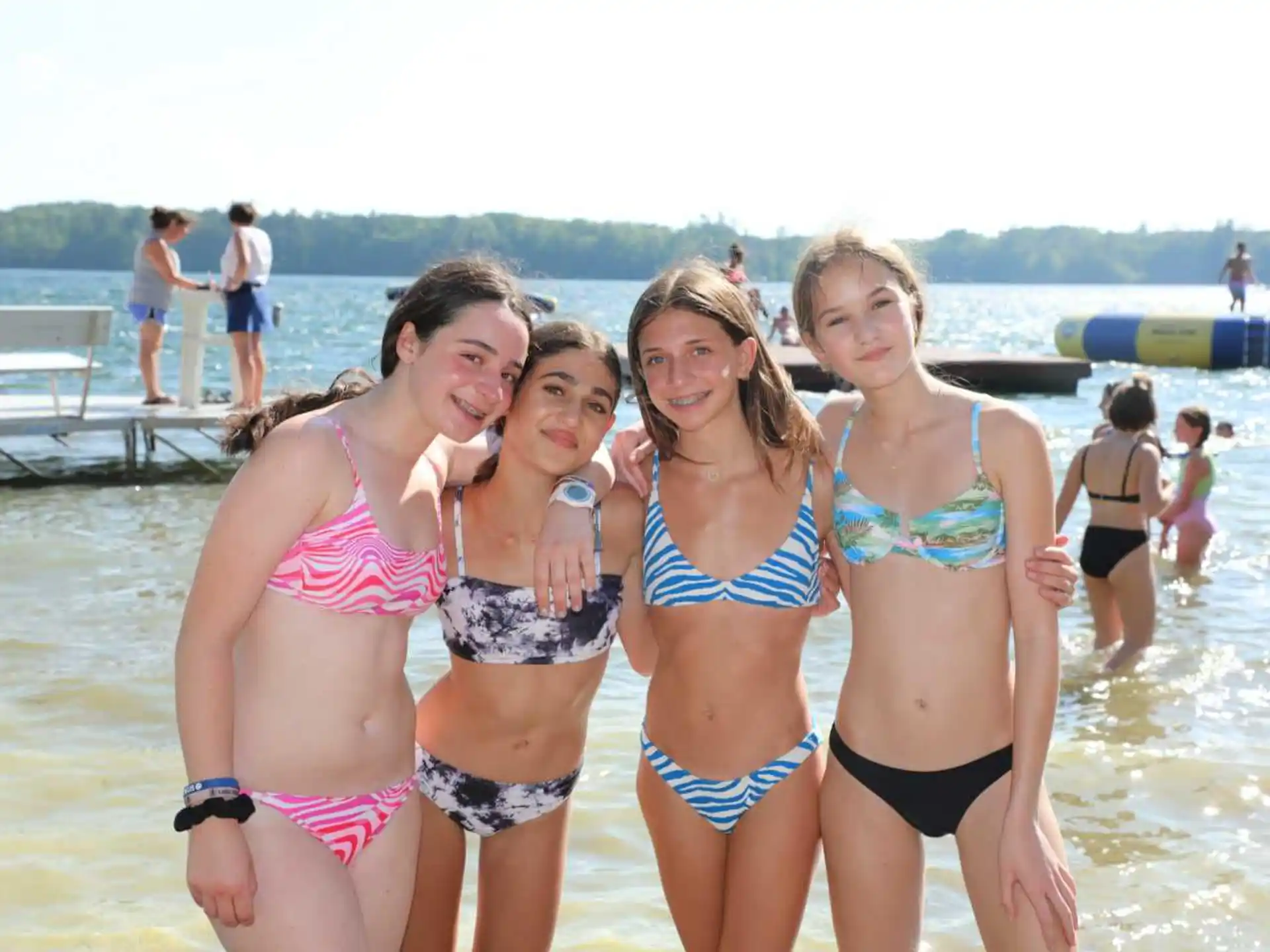 a group of women in garments on a beach