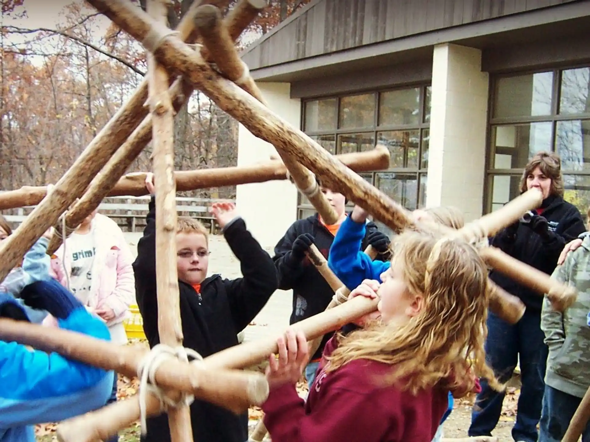 a group of people holding a tree branch