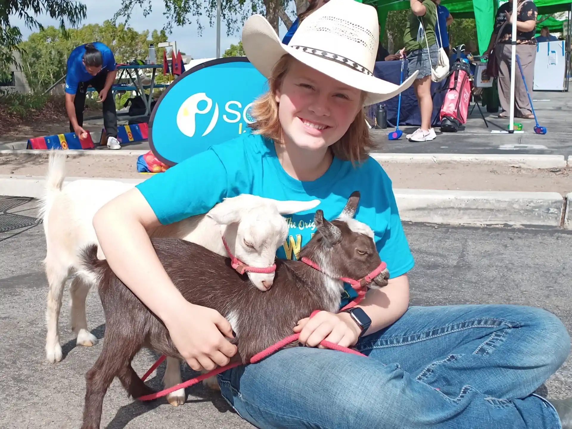 a person holding a couple dogs