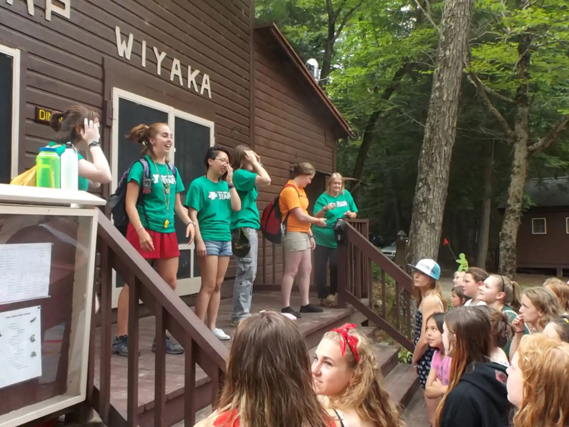 a group of people standing on a porch