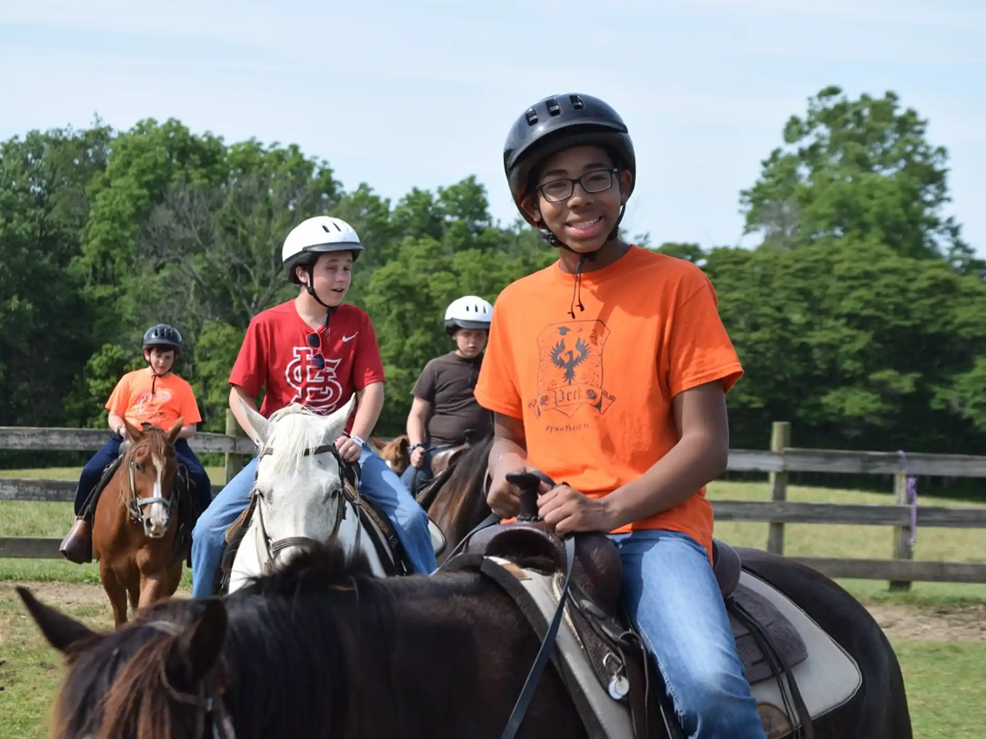a group of people ride horses