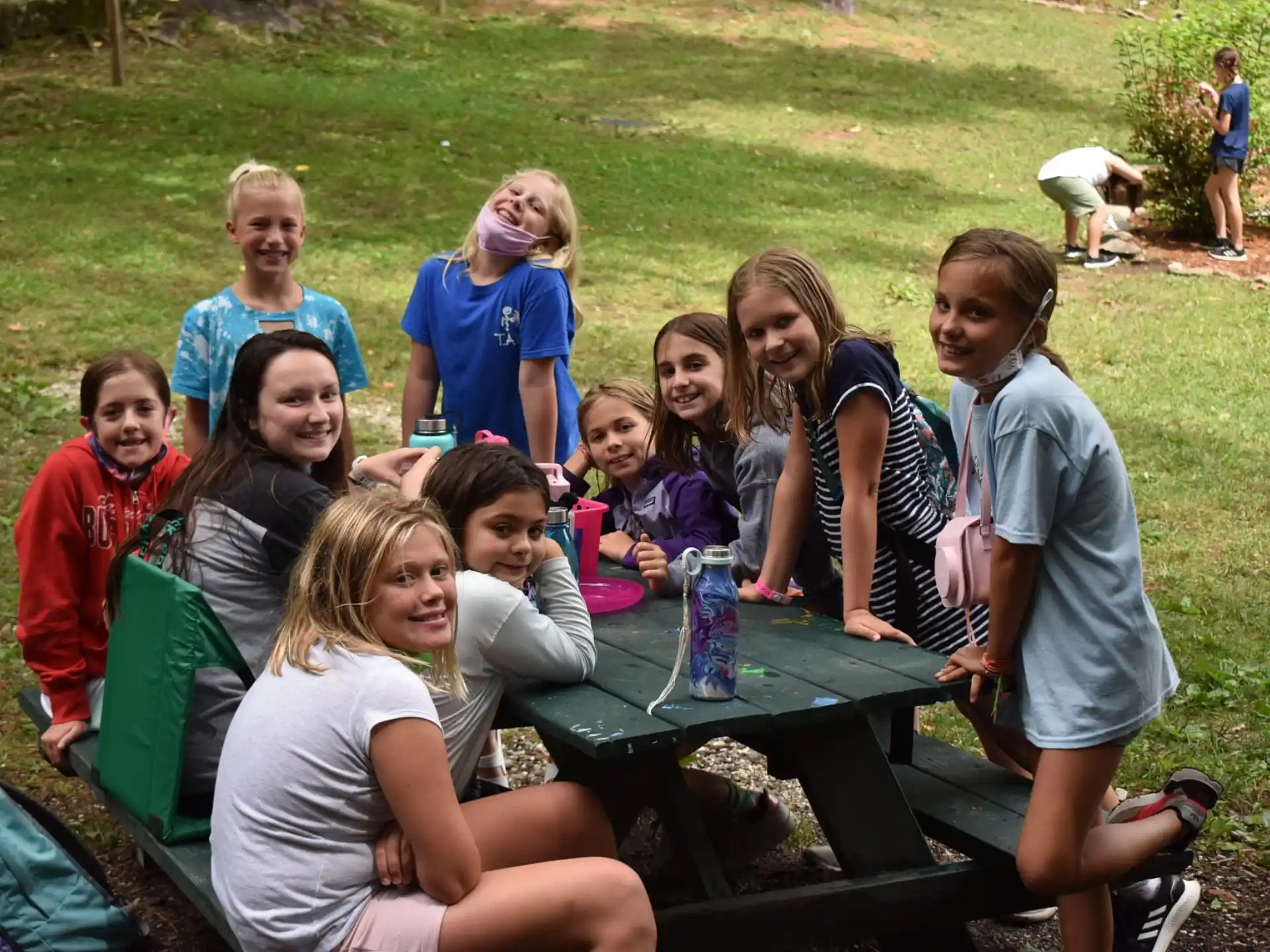 a group of people sitting around a table outside