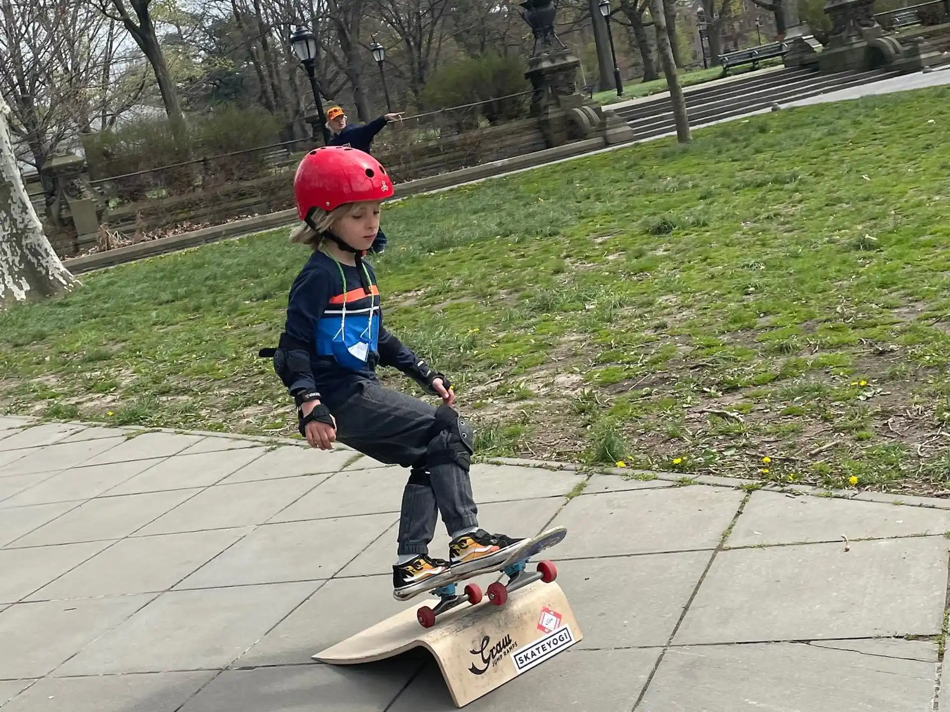 a kid wearing a helmet and riding a skateboard