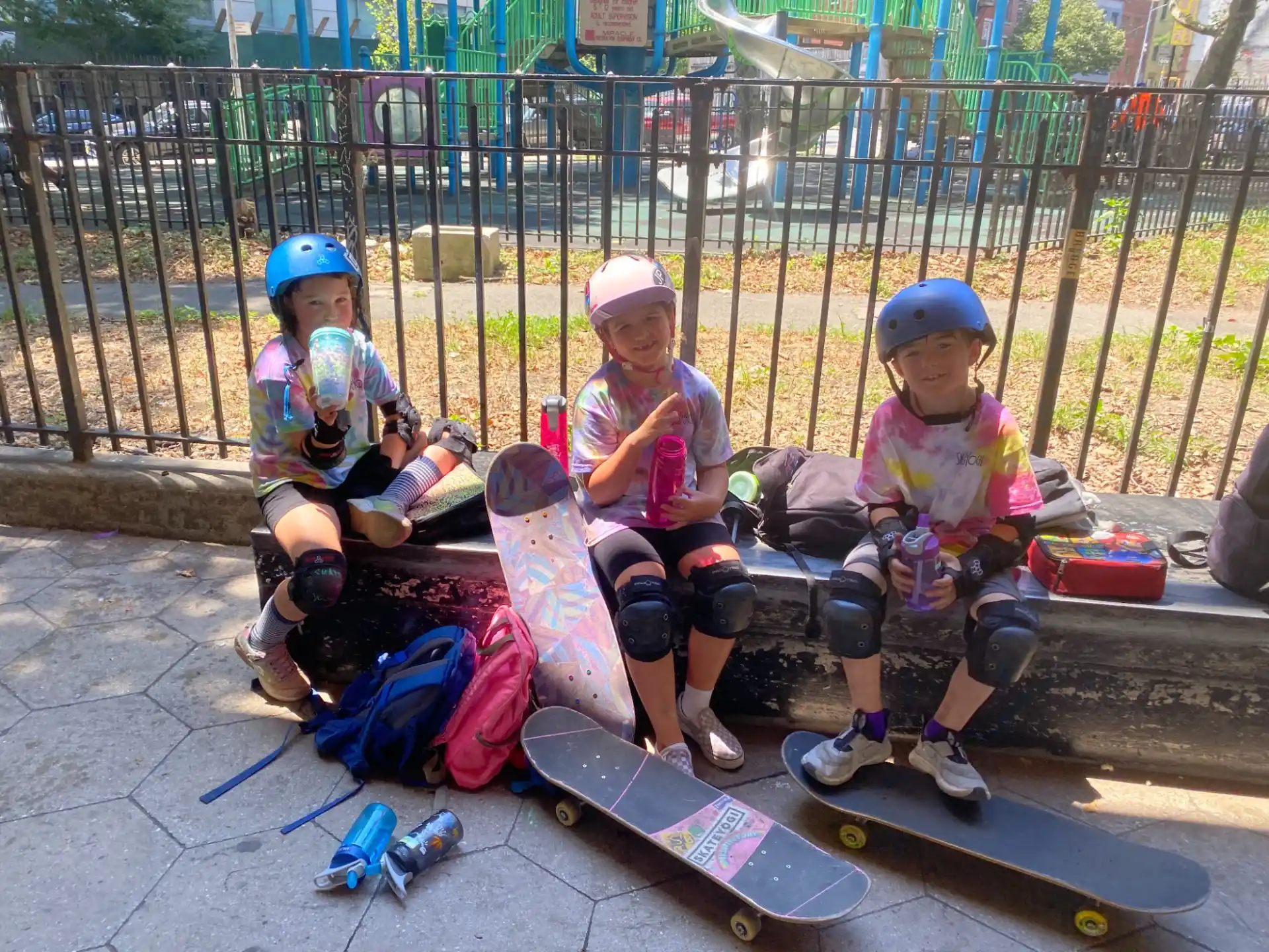 kids with skateboards on a sidewalk