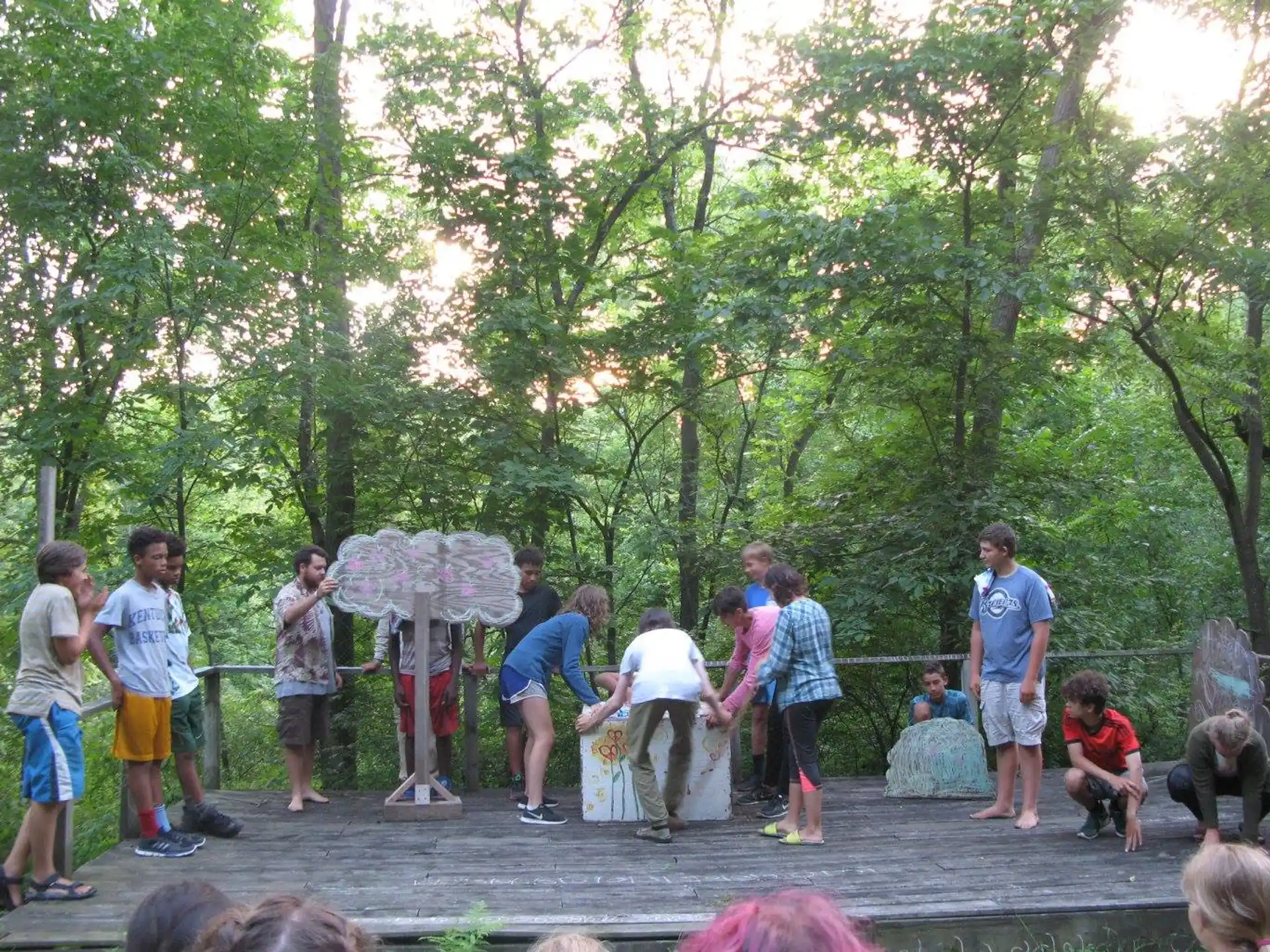 a group of people stand around a fountain