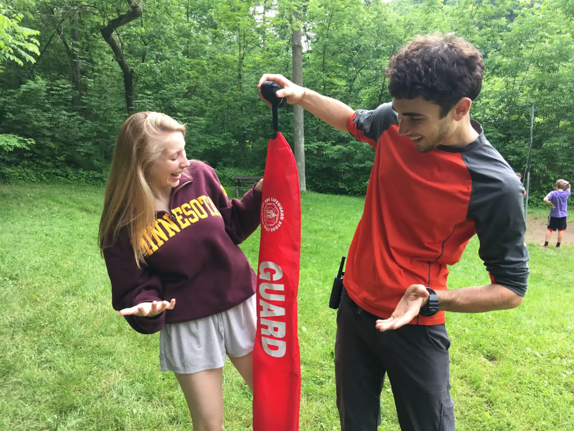 a man and a woman holding a red and white flag